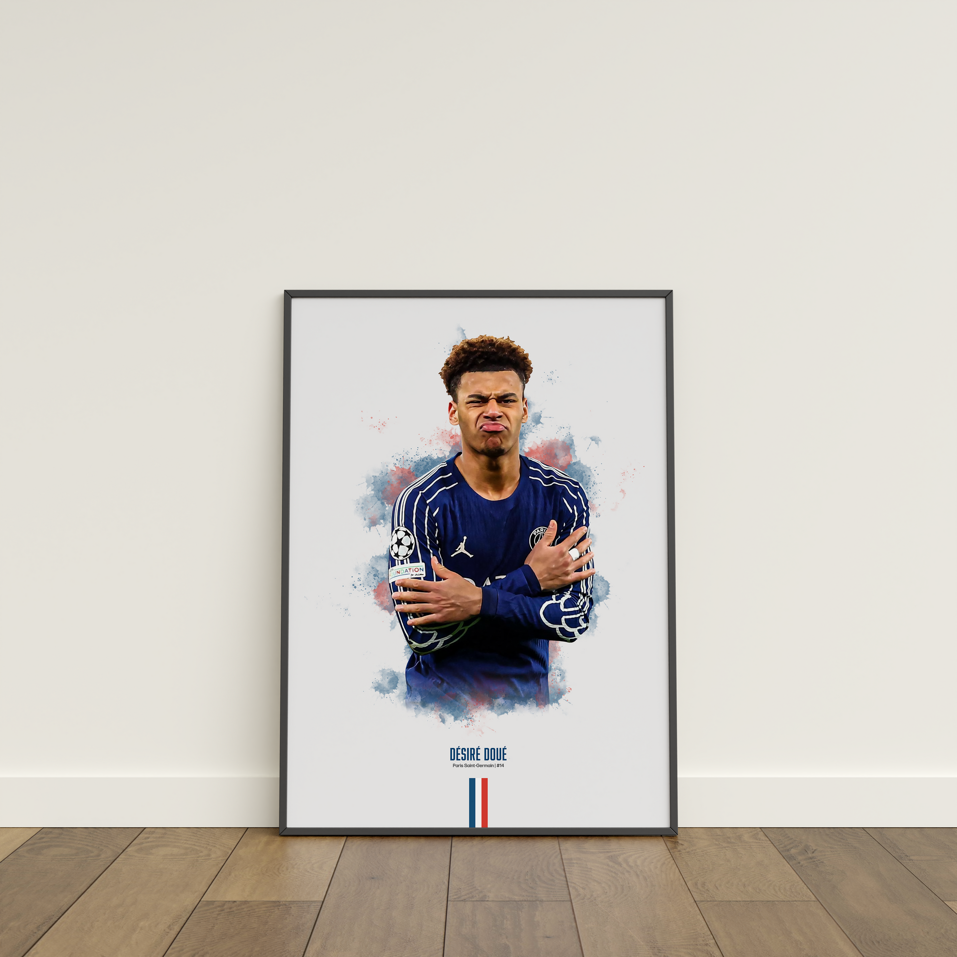 Framed poster print of soccer player Desire Doue, wearing a PSG jersey, on a white wall.