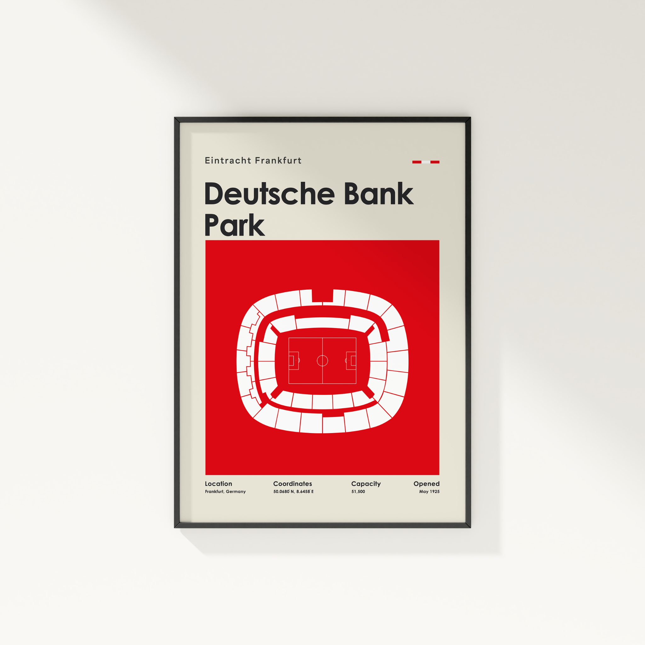 A framed minimalist sports poster of Deutsche Bank Park in Frankfurt, featuring a red and white stadium layout on a light beige background, shown hanging on a white wall.