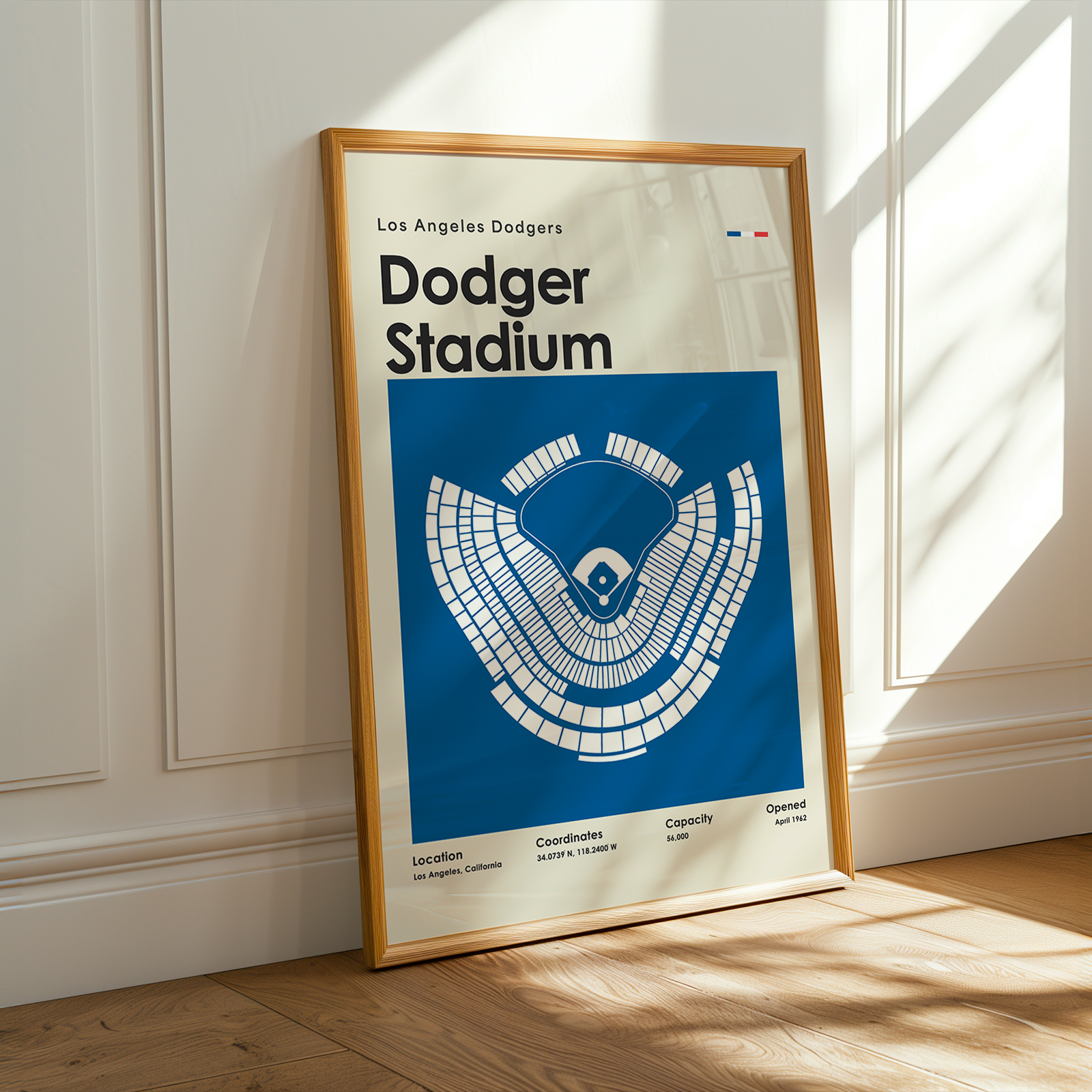Framed poster of Los Angeles Dodgers Dodger Stadium on a wooden floor with sunlight streaming through a window.