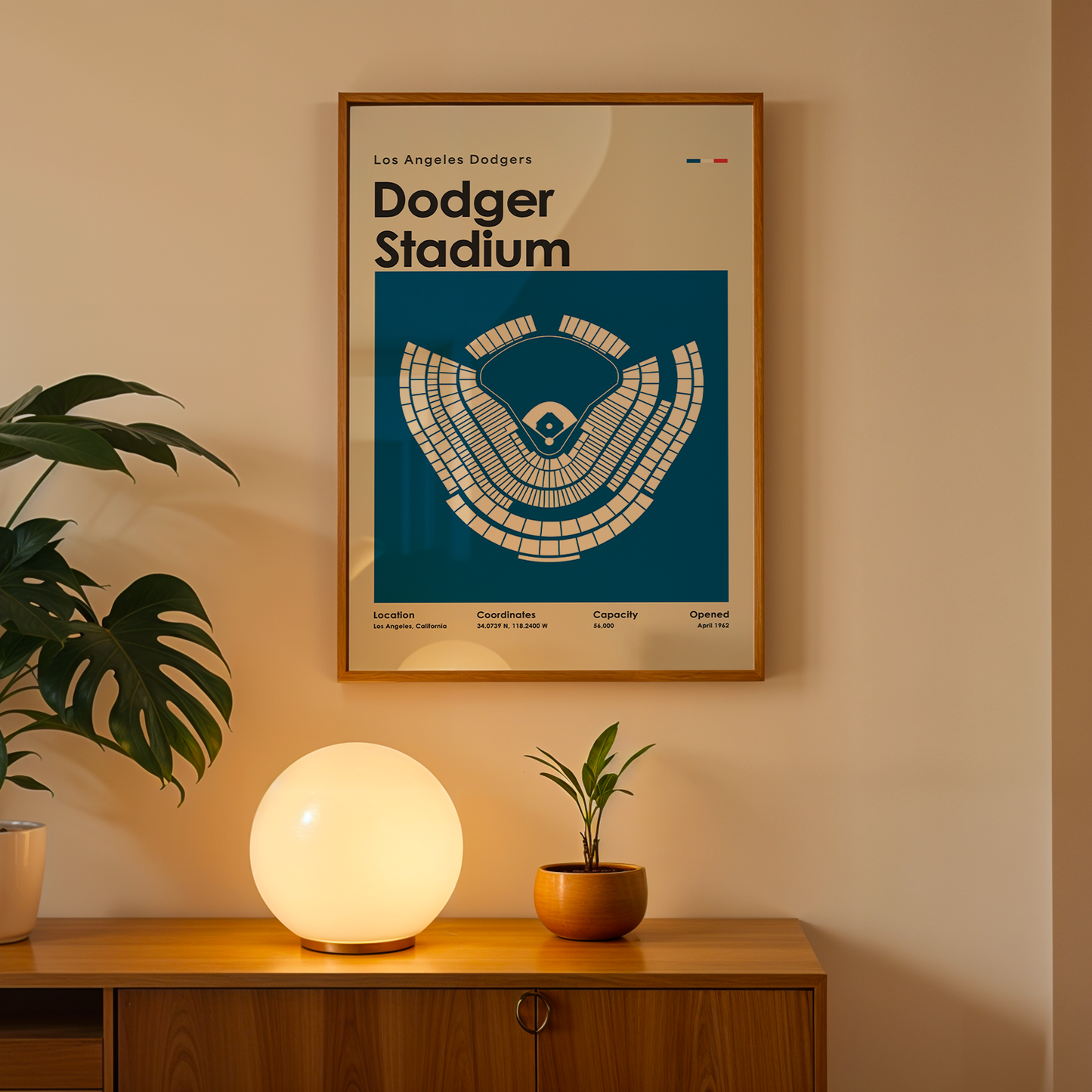 Framed poster of Dodger Stadium on a wall above a wooden cabinet with decorative items.