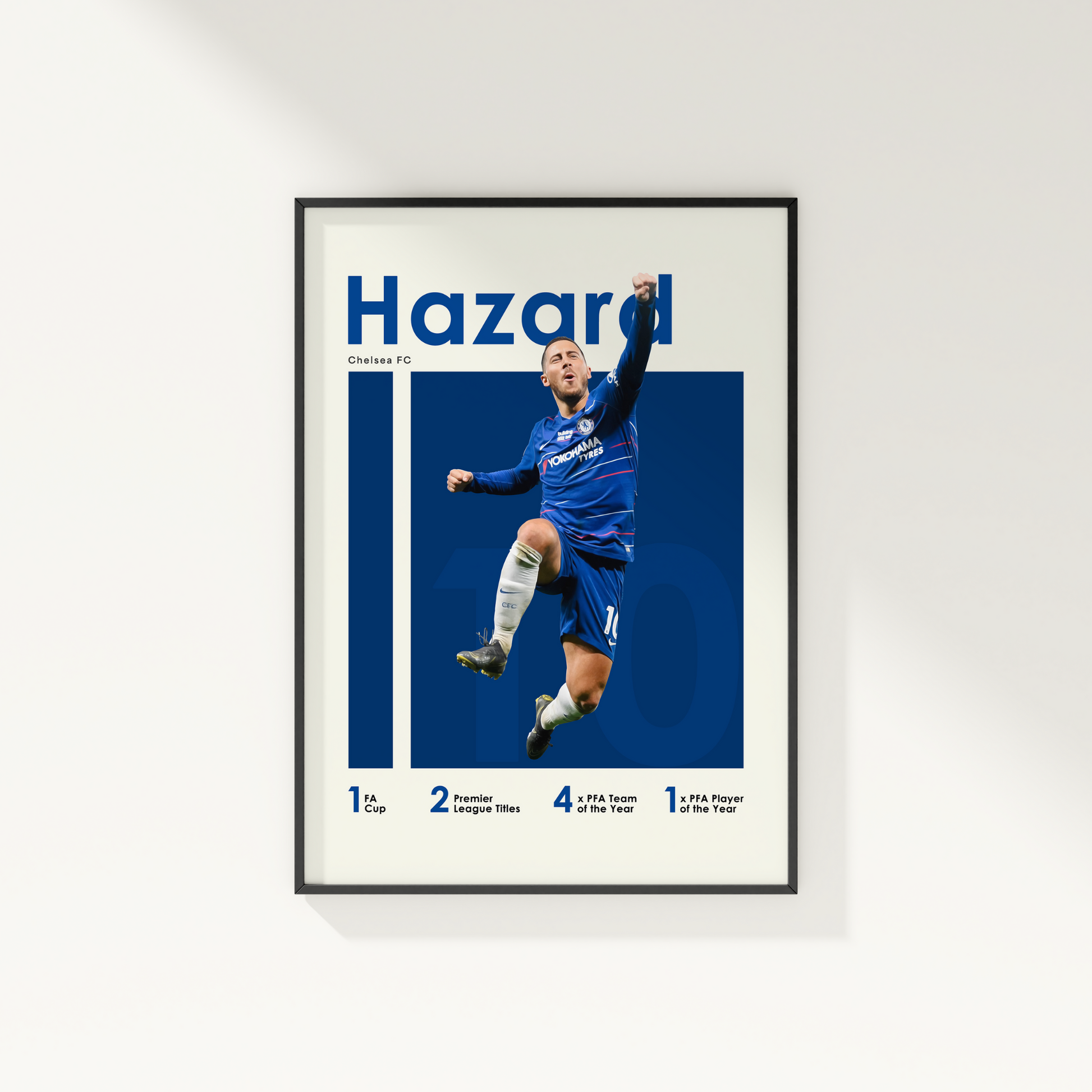 framed poster mockup of soccer player eden hazard hanging on a white wall