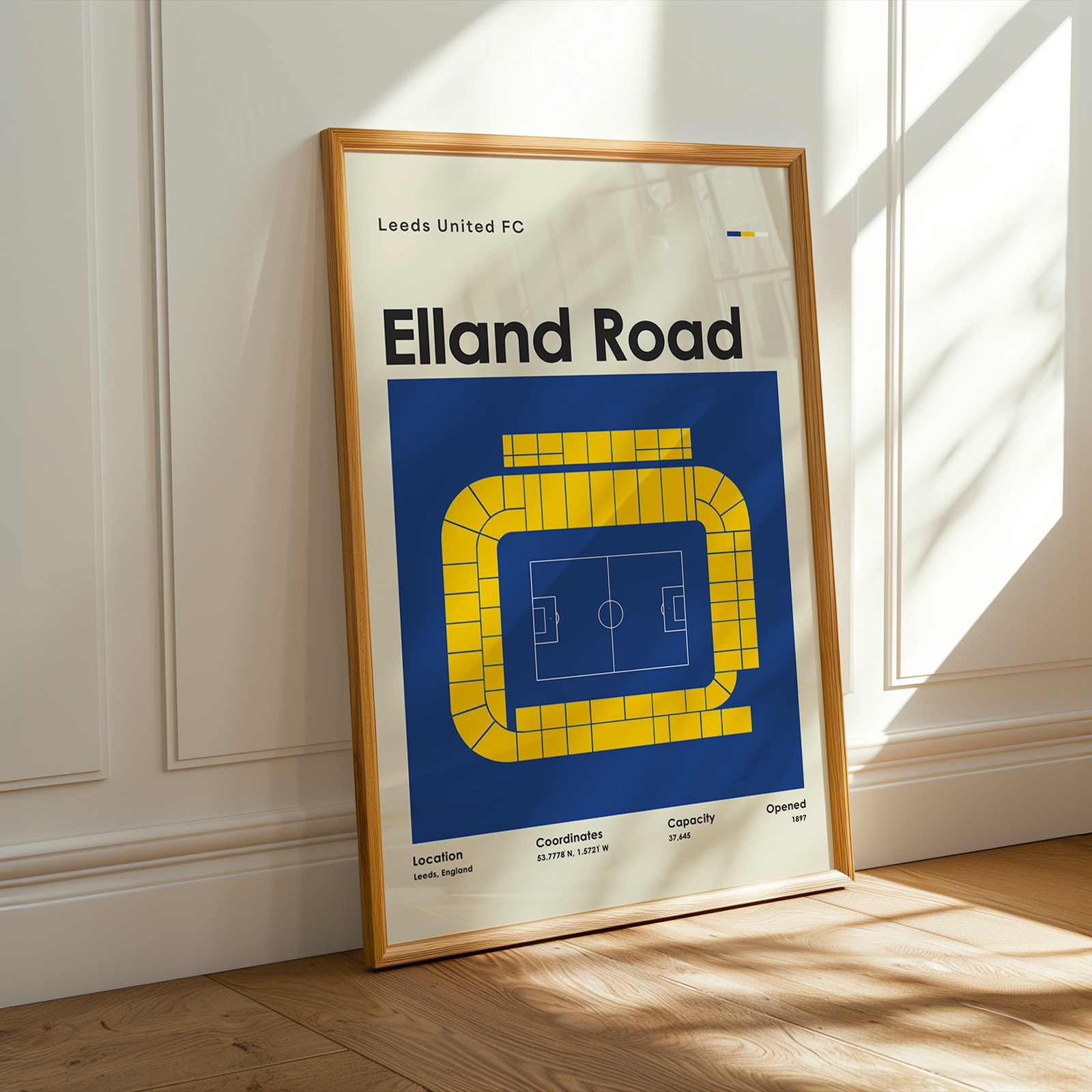 Framed poster of Elland Road stadium layout on a wall.