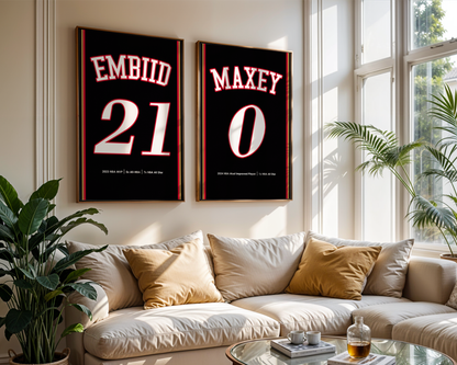 Two framed sports jerseys with names and numbers on a wall above a couch.