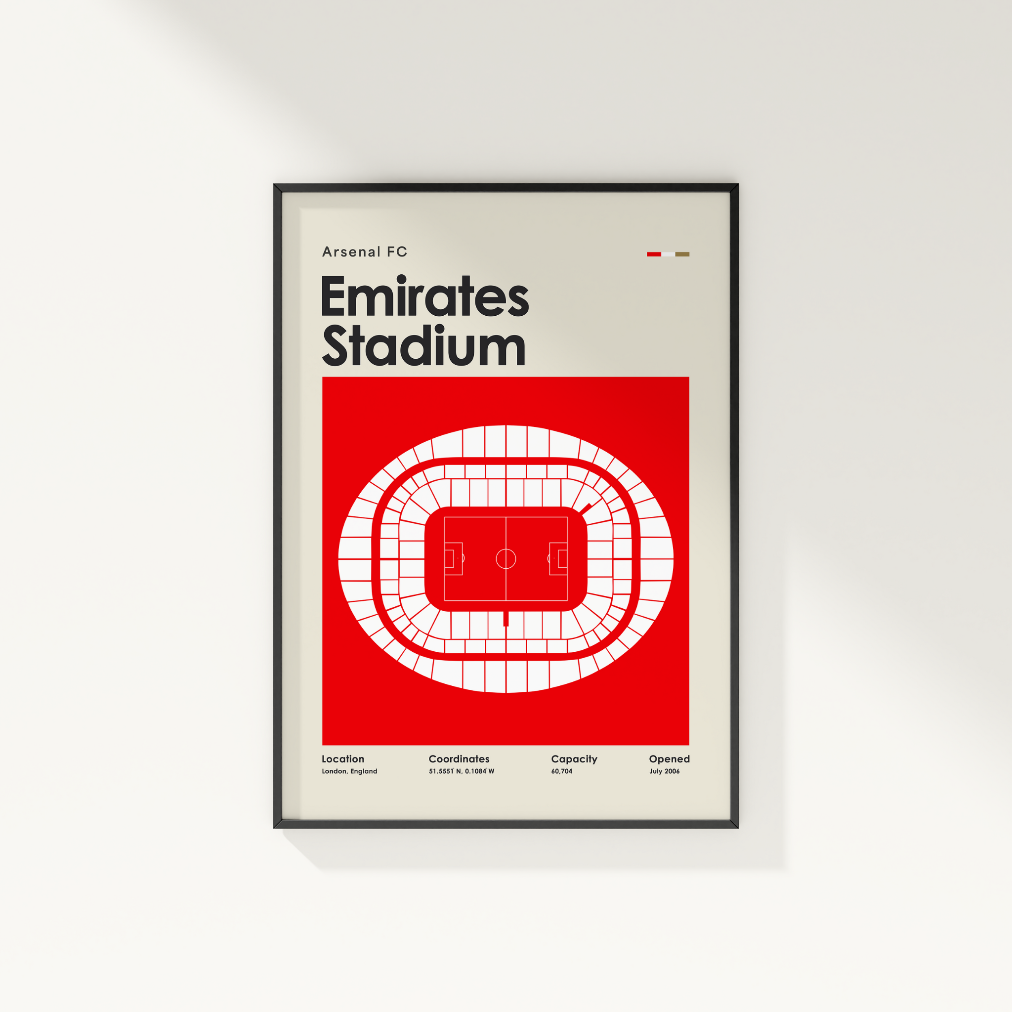 Framed poster of Arsenal FC Emirates Stadium design on a white wall.