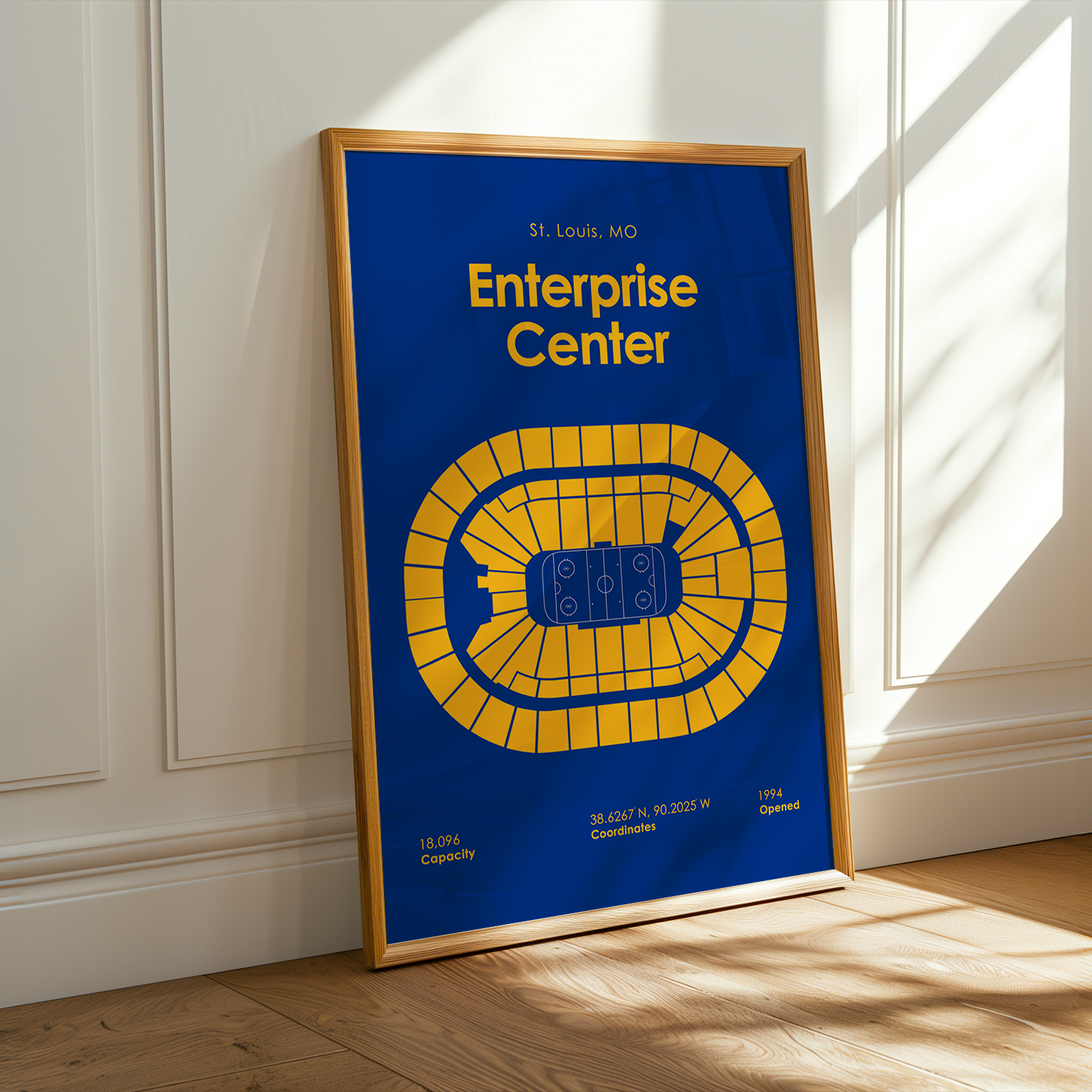 Framed poster of the Enterprise Center in St. Louis, MO on a wall.