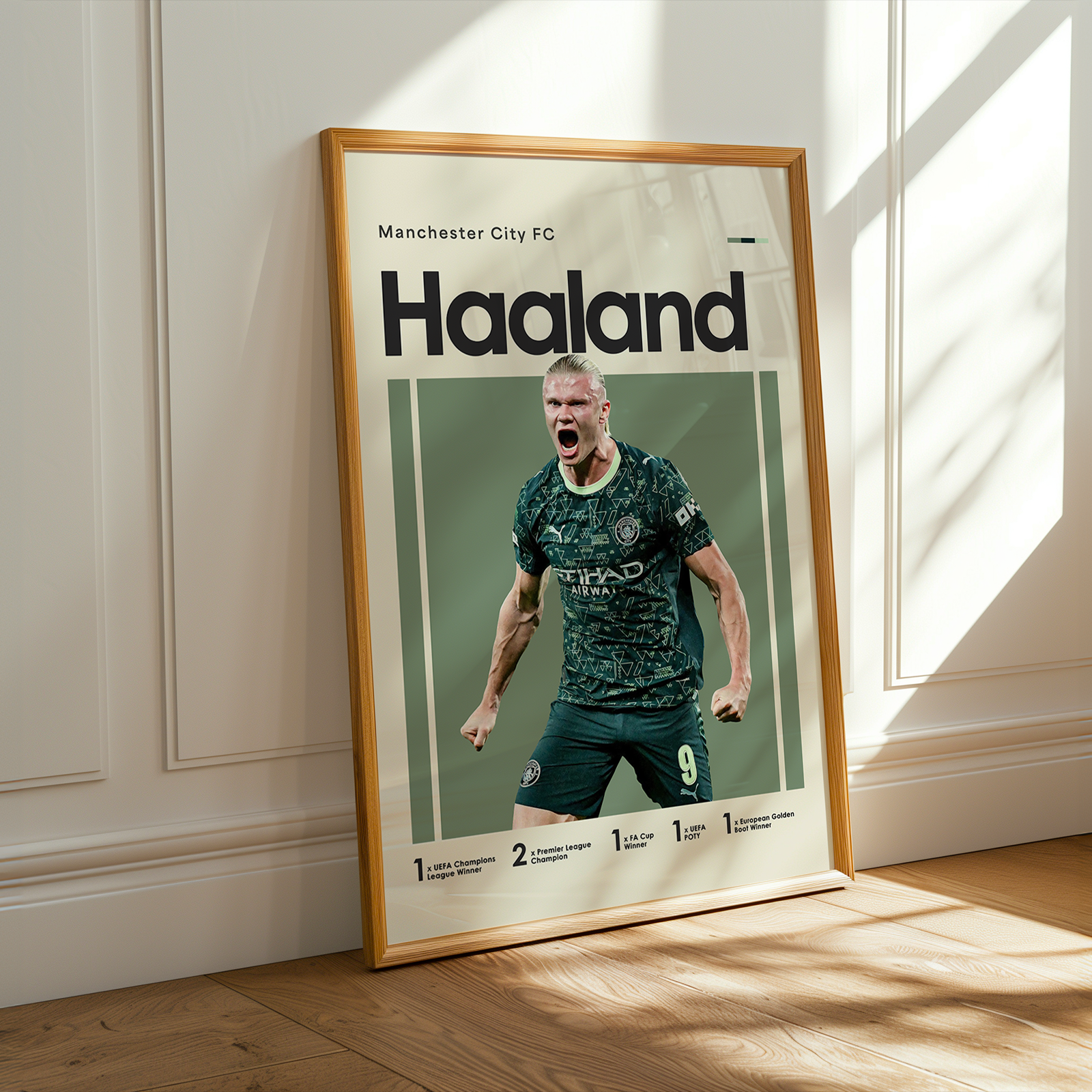 Framed poster of a soccer player with 'Haaland' on a wall.