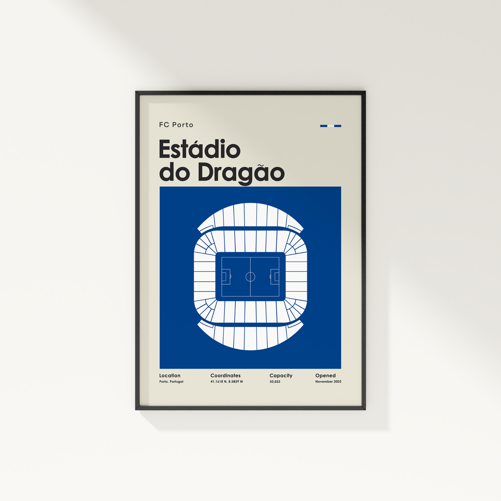 A framed minimalist poster of Estãdio do Dragõn from FC Porto, featuring a blue and white stadium floor plan on a light beige background, displayed on a clean white wall.
