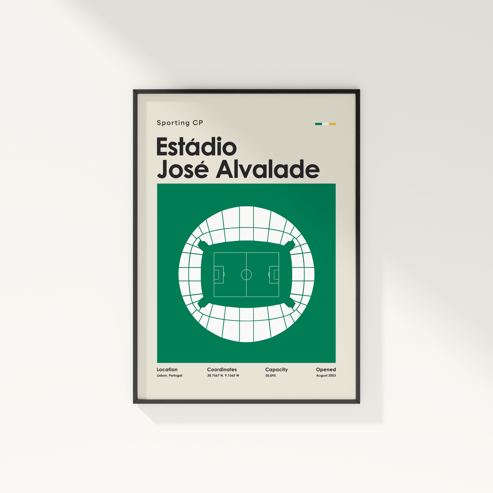A framed sports poster of Estãdio José Alvalade from Sporting CP, featuring a green and white stadium floor plan on a light beige background, displayed on a white wall.