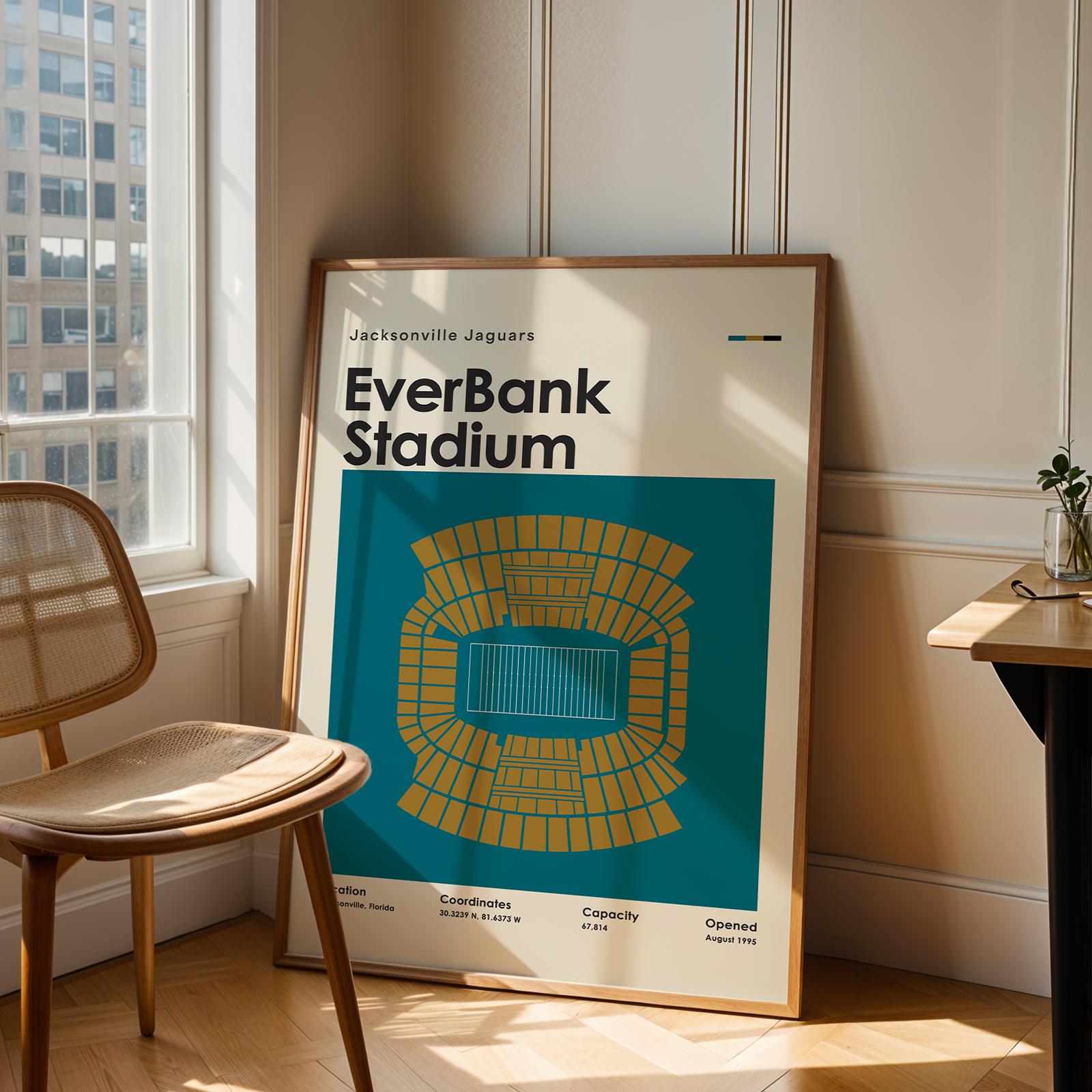 Framed poster of EverBank Stadium in a room with a chair and table.