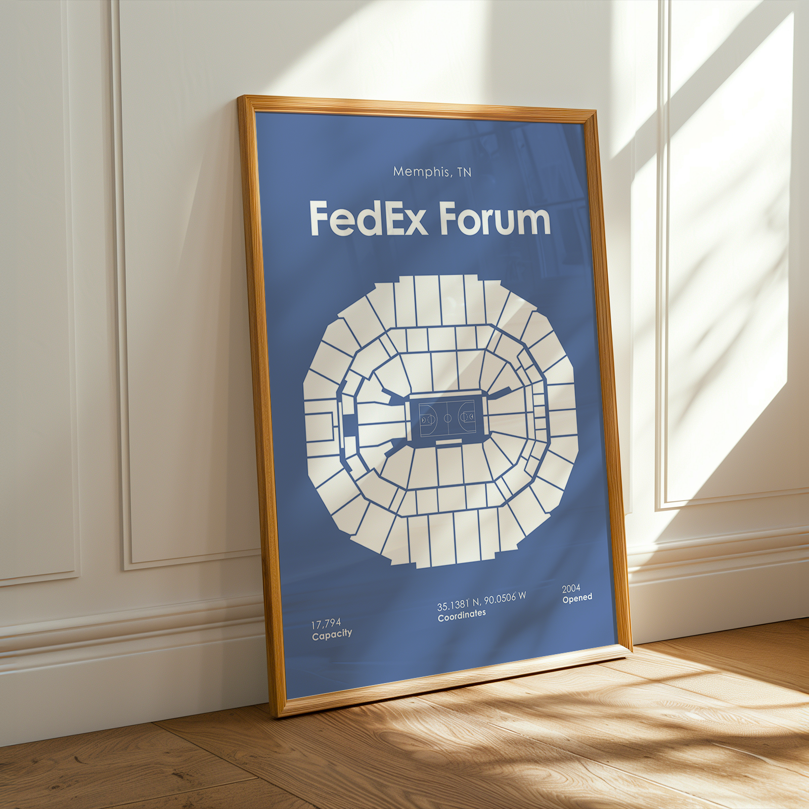 Framed map of FedEx Forum on a wooden floor with sunlight streaming through a window.