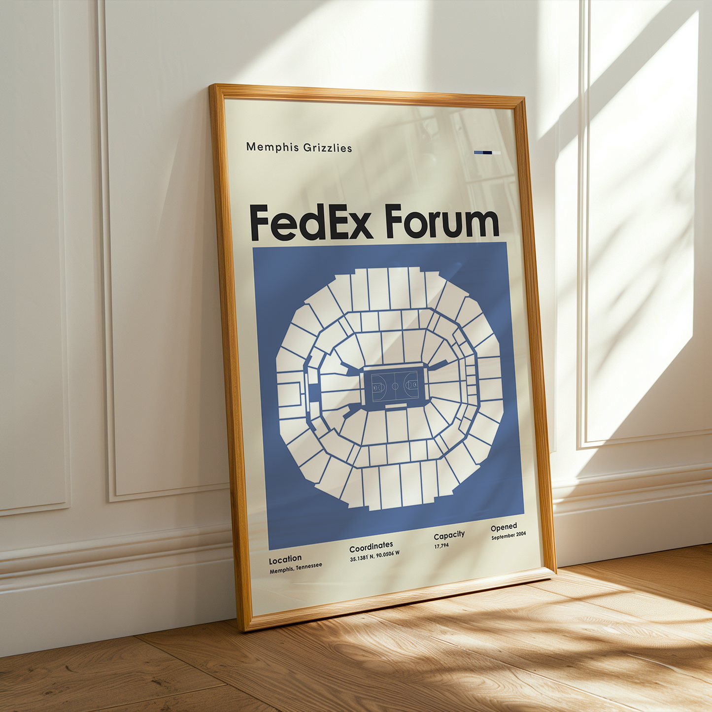 Framed poster of FedEx Forum layout on a wall with sunlight casting shadows.