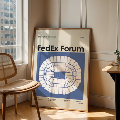 Framed poster of FedEx Forum in a room with a chair and table.