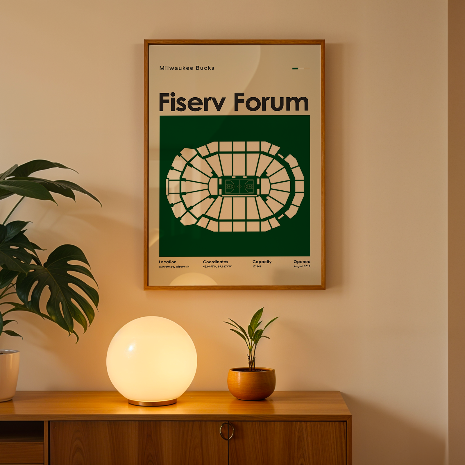 Poster of Fiserv Forum on a wall above a wooden cabinet with decorative items.