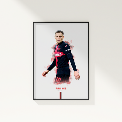 framed poster mockup of soccer player florian wirtz hanging on a white wall