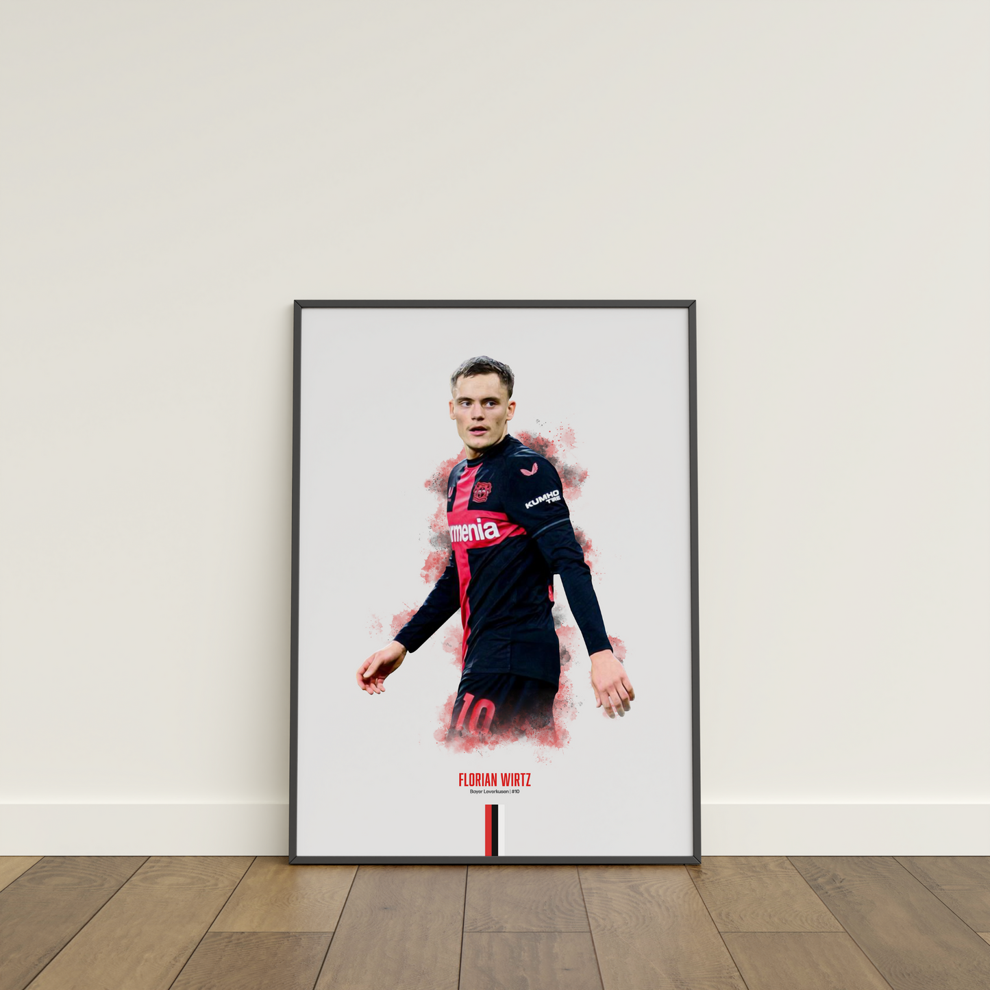 framed poster mockup of soccer player florian wirtz leaning on a white wall