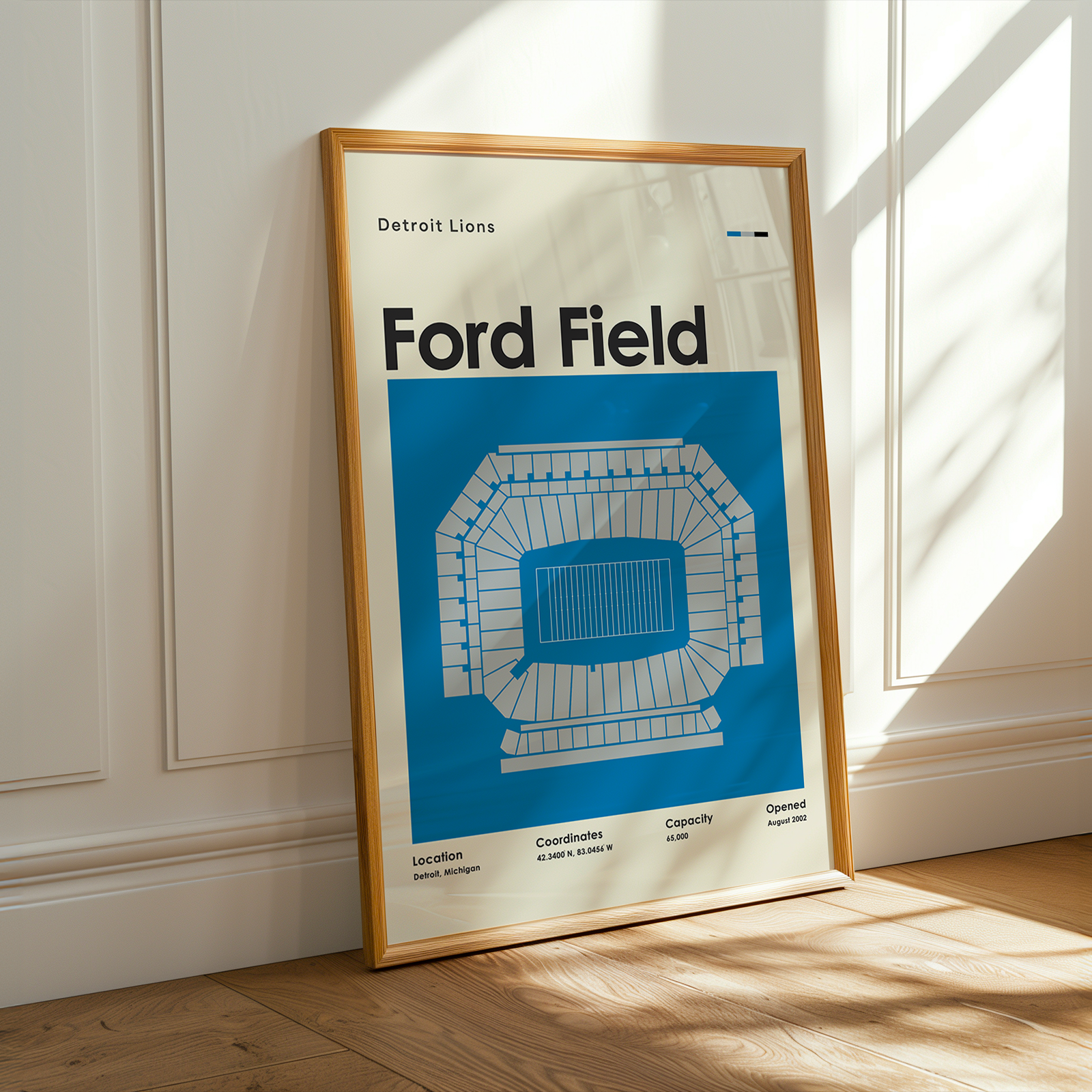 Framed poster of Ford Field with Detroit Lions branding on a wall.