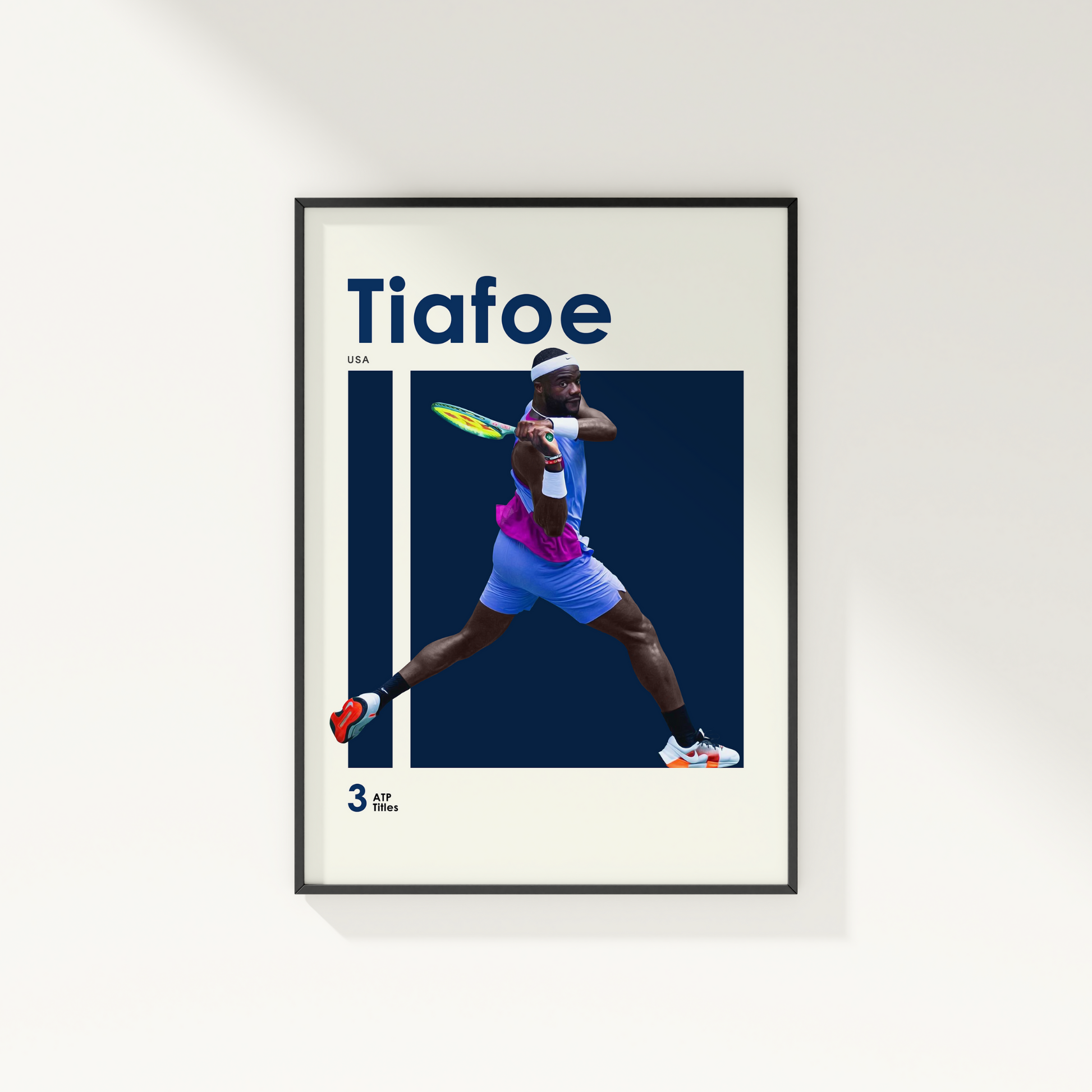 framed poster mockup of tennis player frances tiafoe hanging on a white wall