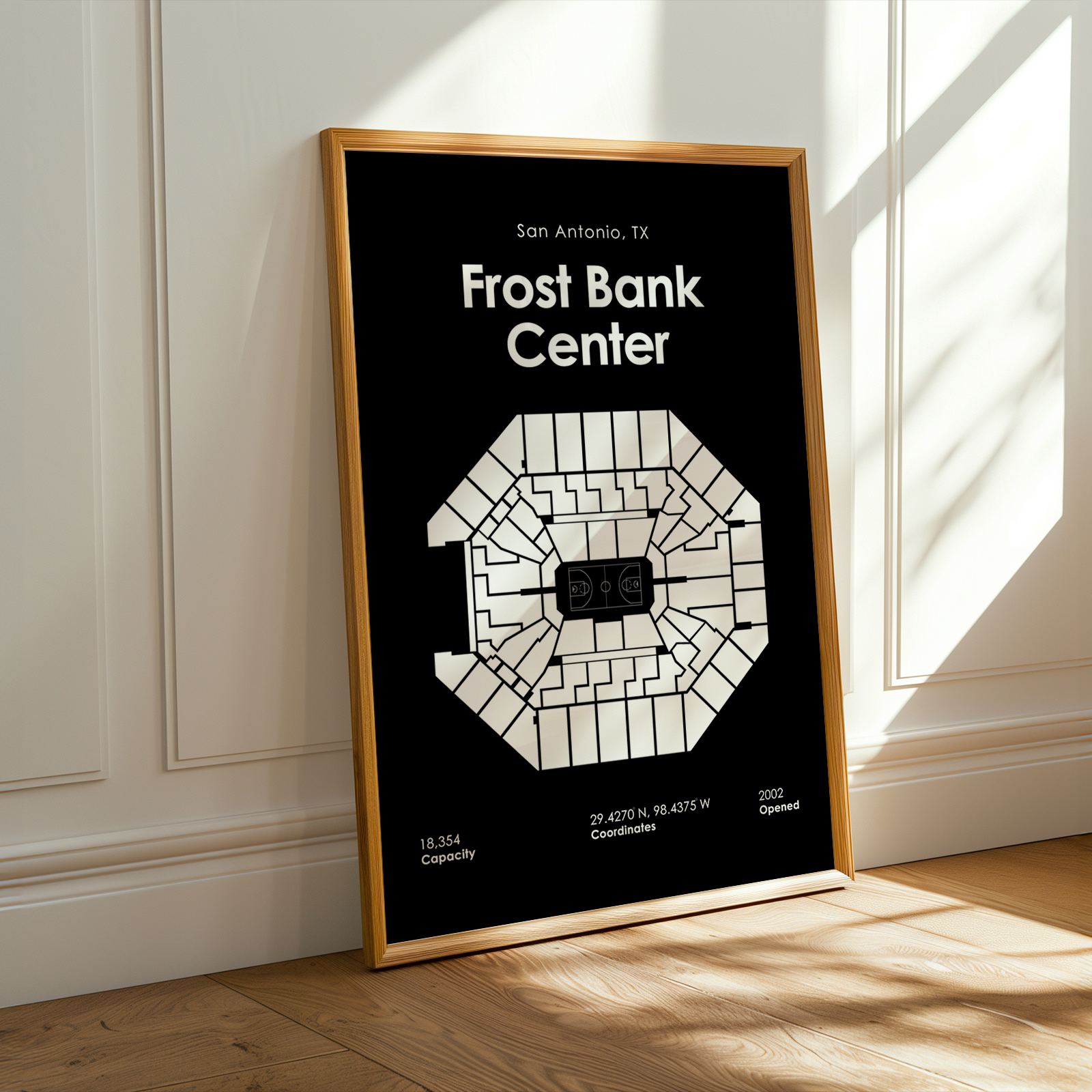 Framed poster of Frost Bank Center layout on a wall.