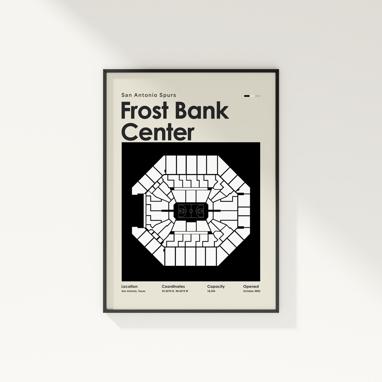 Framed poster of Frost Bank Center with seating chart and text on a white wall.