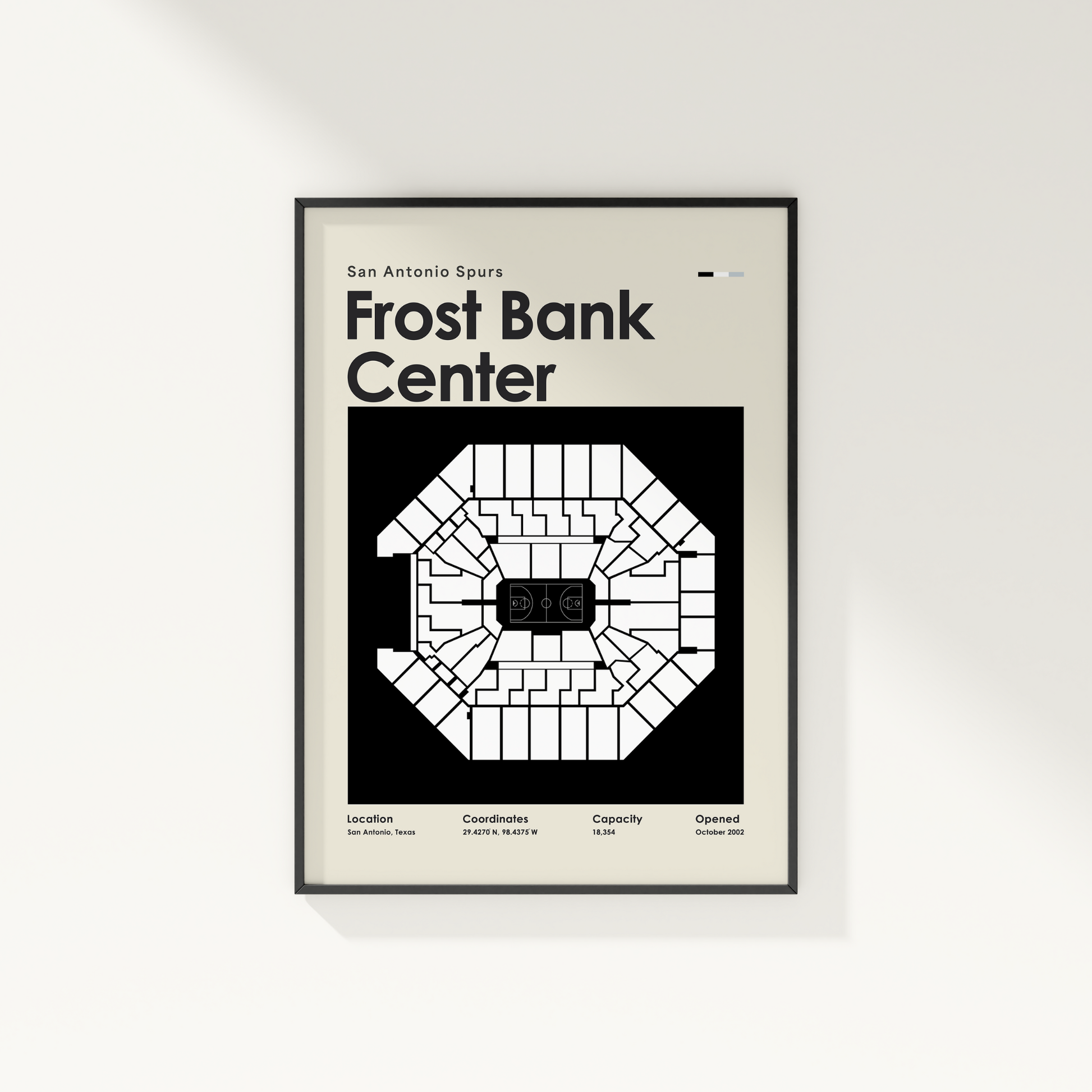Framed poster of Frost Bank Center with seating chart and text on a white wall.