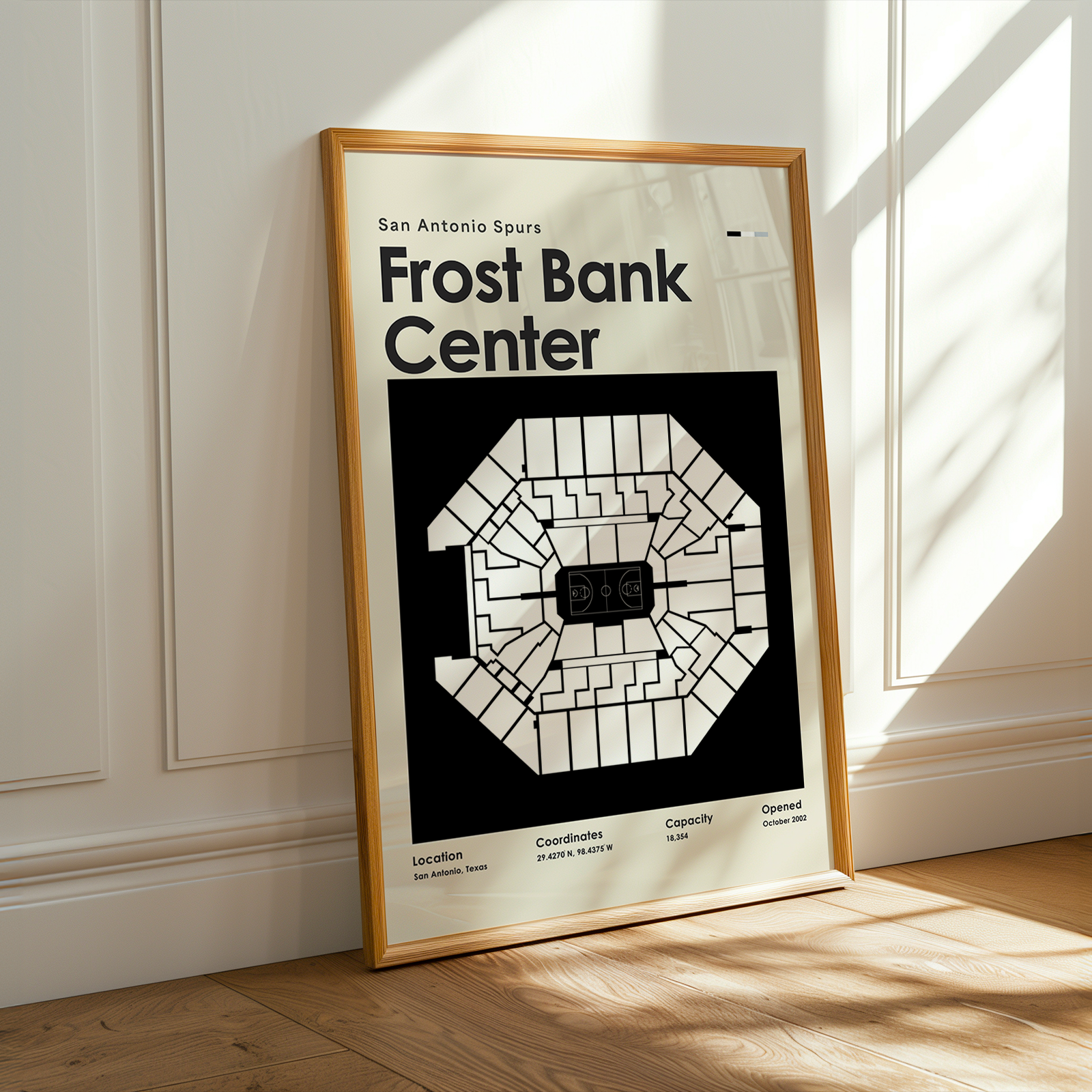 Framed poster of Frost Bank Center in a room with sunlight streaming through a window.