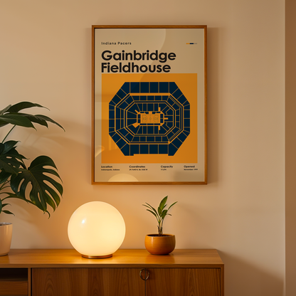 Framed poster of Gainbridge Fieldhouse on a wall above a wooden cabinet with decorative items.