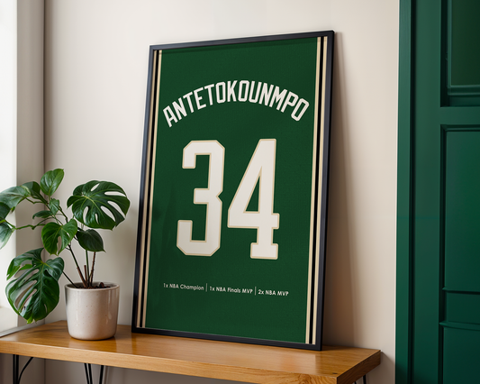 Framed sports jersey with 'ANTETOKOUNMPO 34' on a wooden shelf.