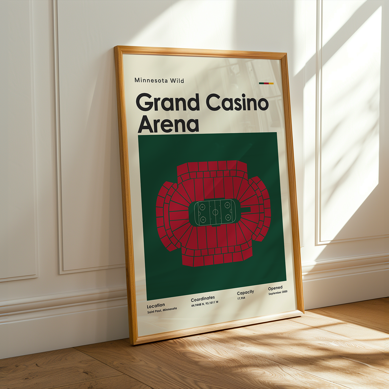 Framed poster of Grand Casino Arena with wooden frame on a light-colored wall.