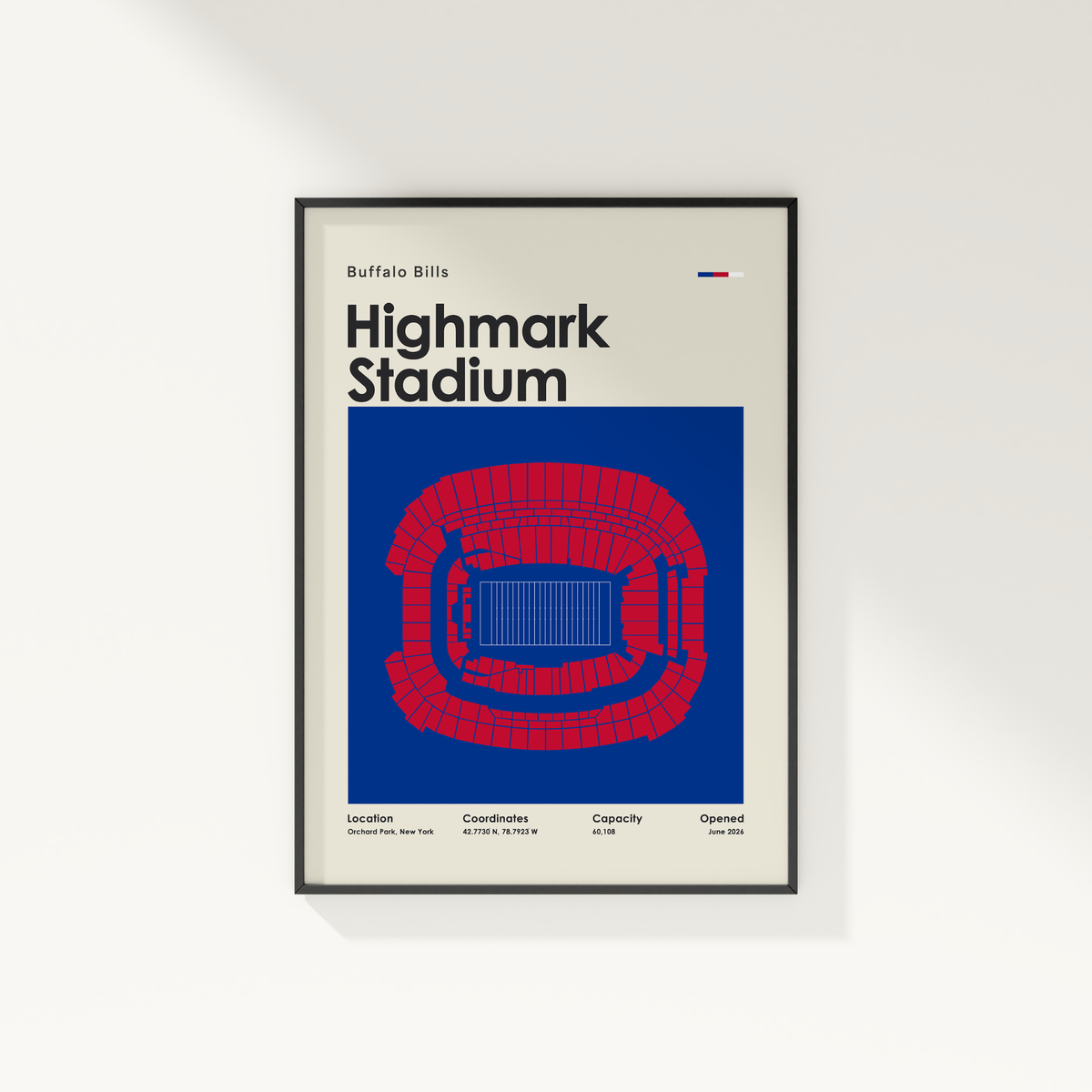 A framed Buffalo Bills Highmark Stadium poster hanging on a light gray wall. The poster features a cream background with bold black text and a large blue graphic showing a red stadium layout.