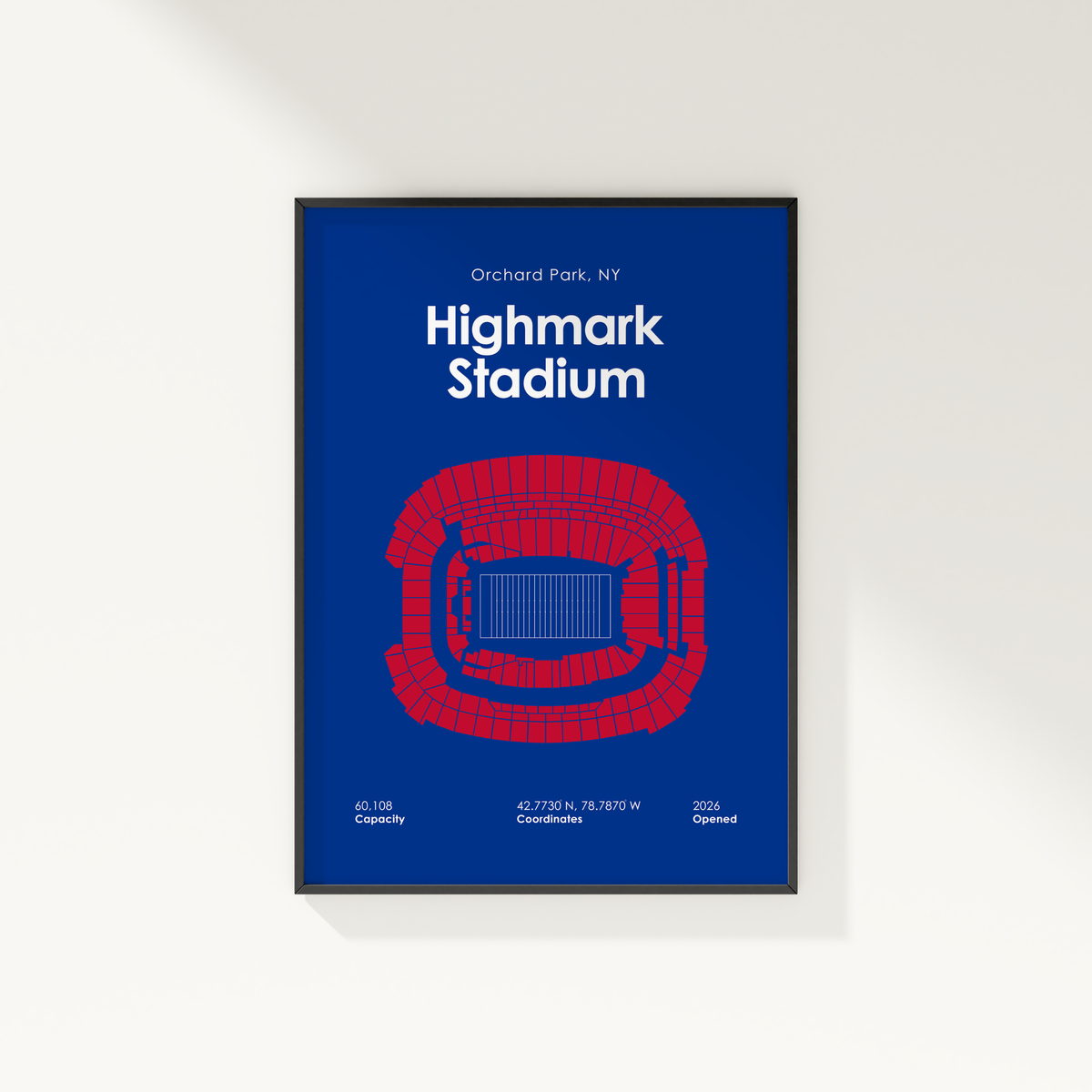 A framed poster of Highmark Stadium in Orchard Park, NY, featuring a blue background with a red stadium outline and white text, shown hanging on a light gray wall.