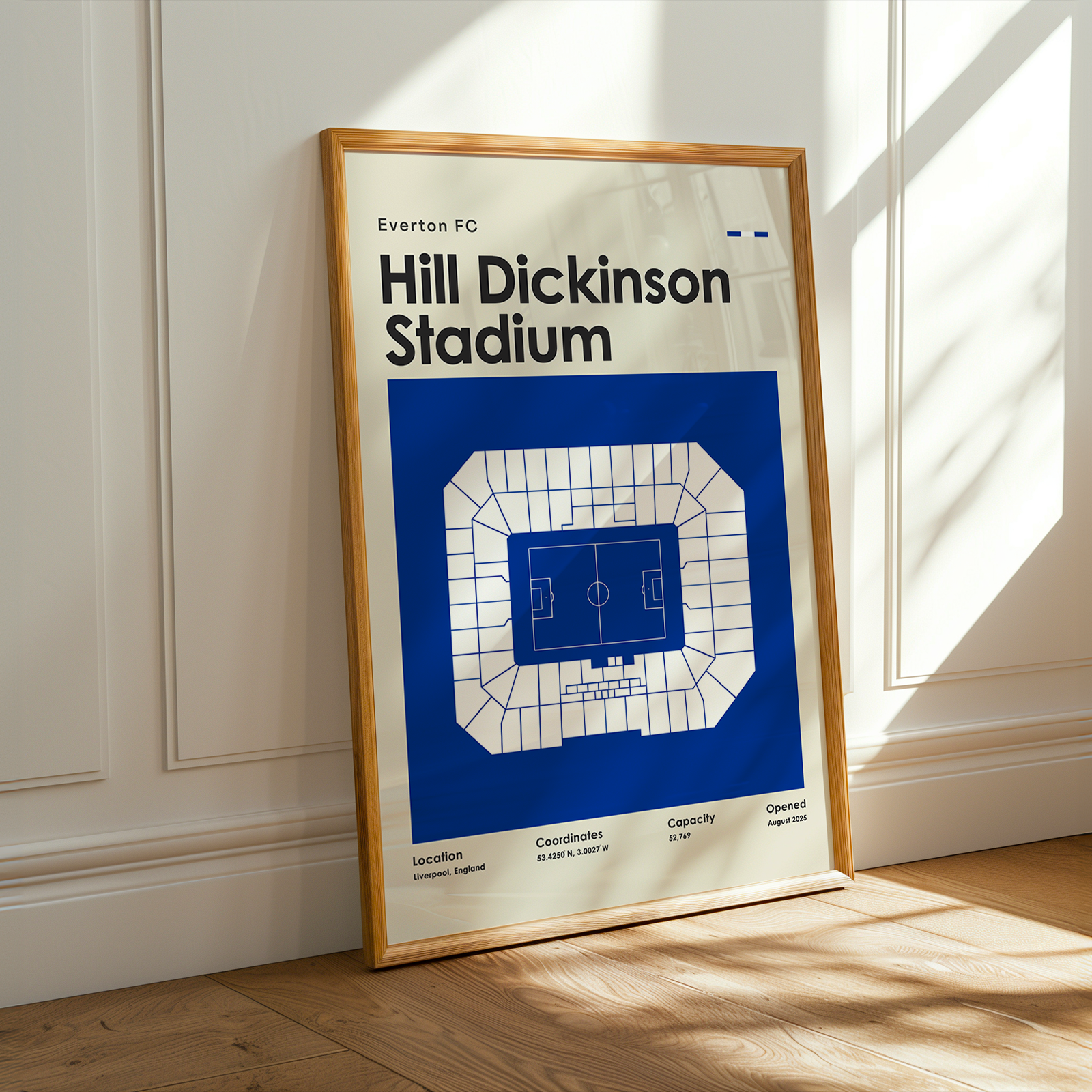 Framed poster of Hill Dickinson Stadium with a wooden frame on a light wooden floor.