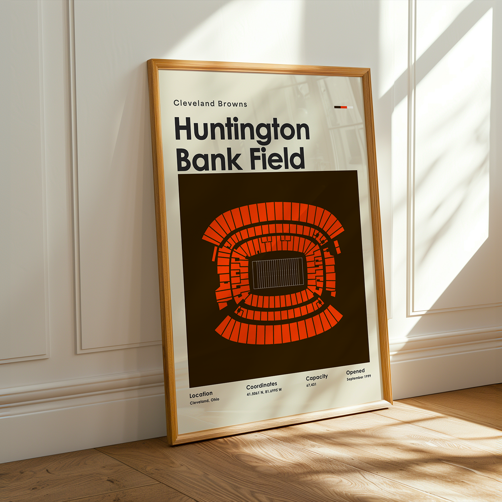 Framed poster of Huntington Bank Field with Cleveland Browns logo on a wall.