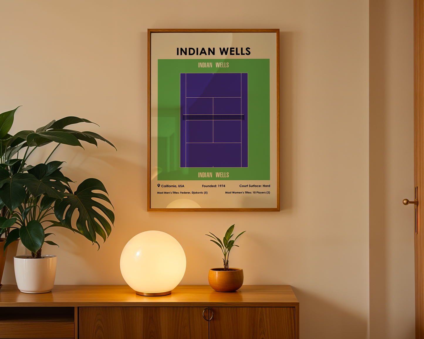 Framed poster of Indian Wells tennis tournament on a wall above a wooden cabinet with decorative items.