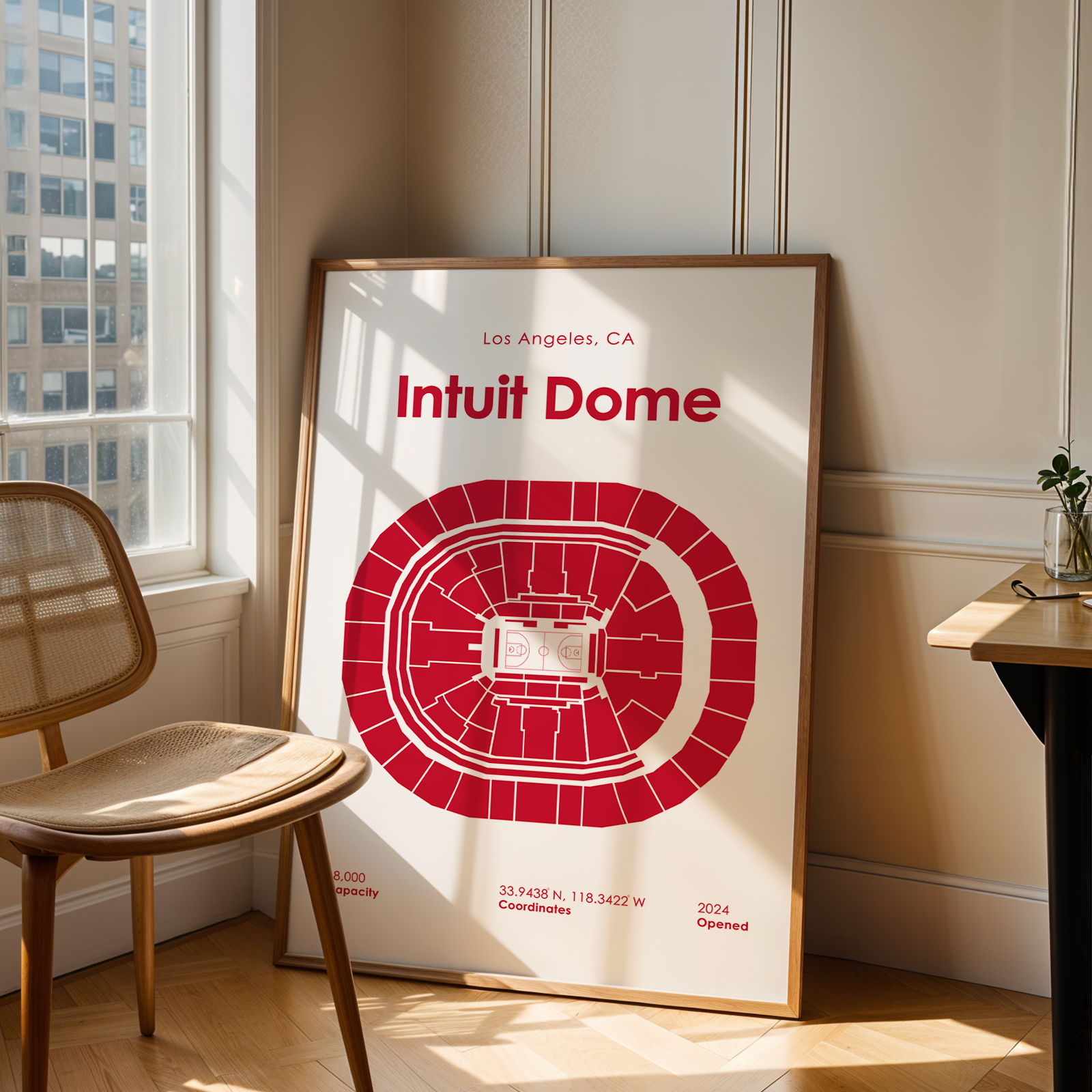 Poster of Intuit Dome in a room with a chair and table.