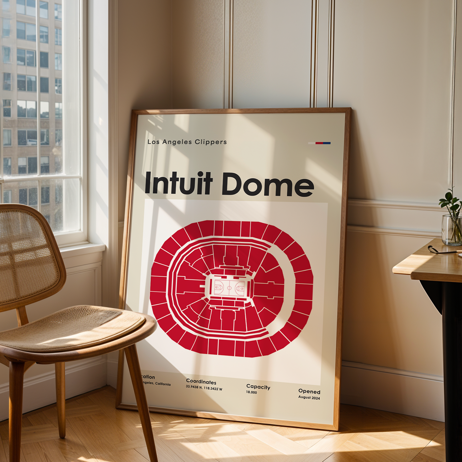 Poster of Intuit Dome with Los Angeles Clippers branding in a room with a chair and table.