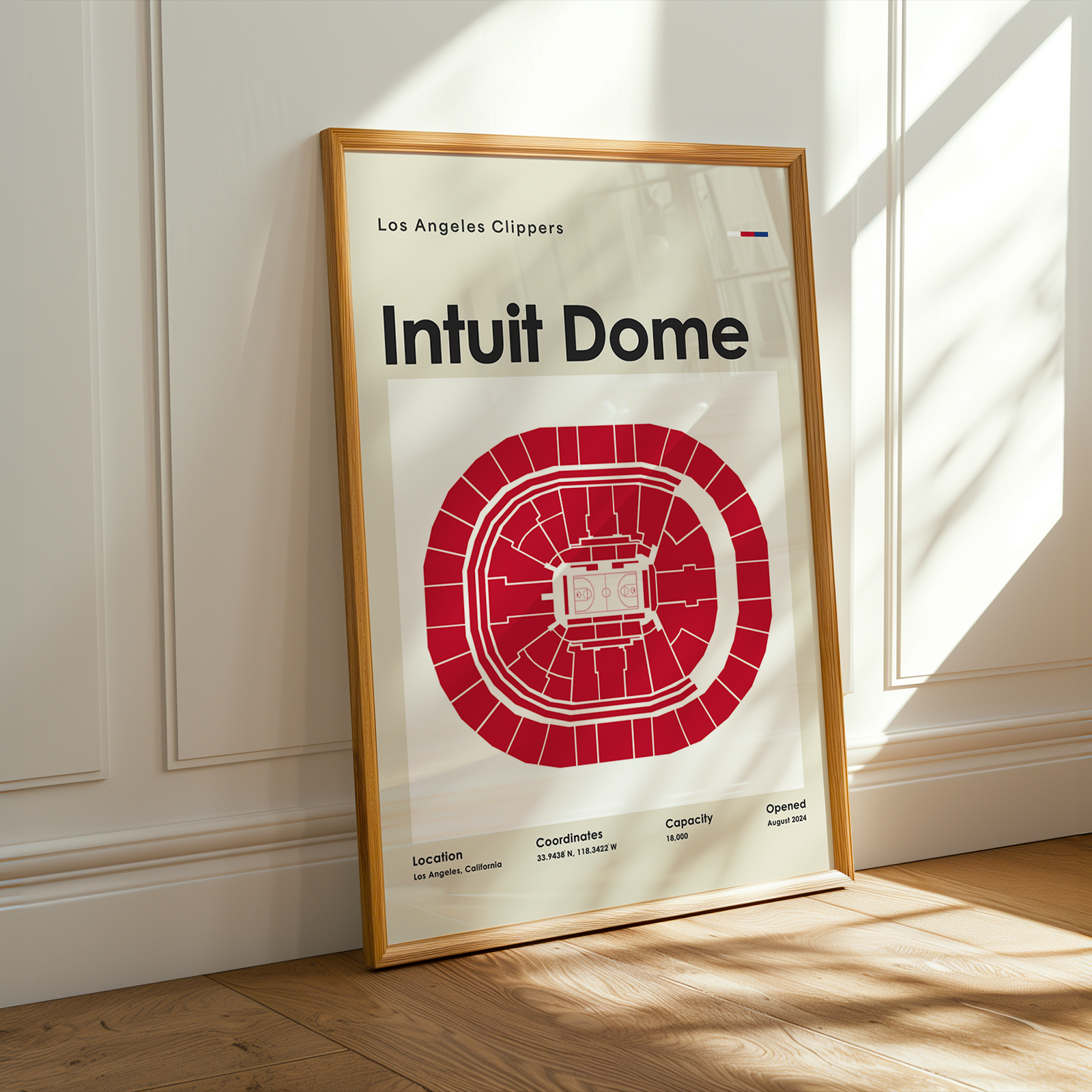 Framed poster of Intuit Dome with Los Angeles Clippers branding on a wall.