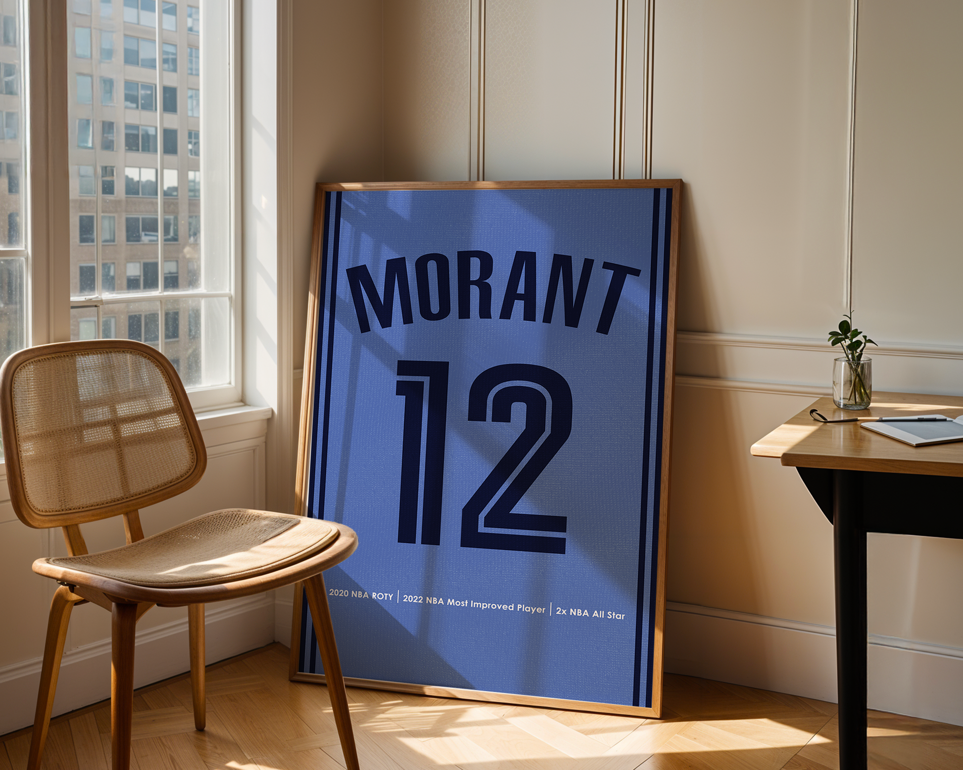 Framed sports jersey with 'Morant 12' in a room with a window and chair.