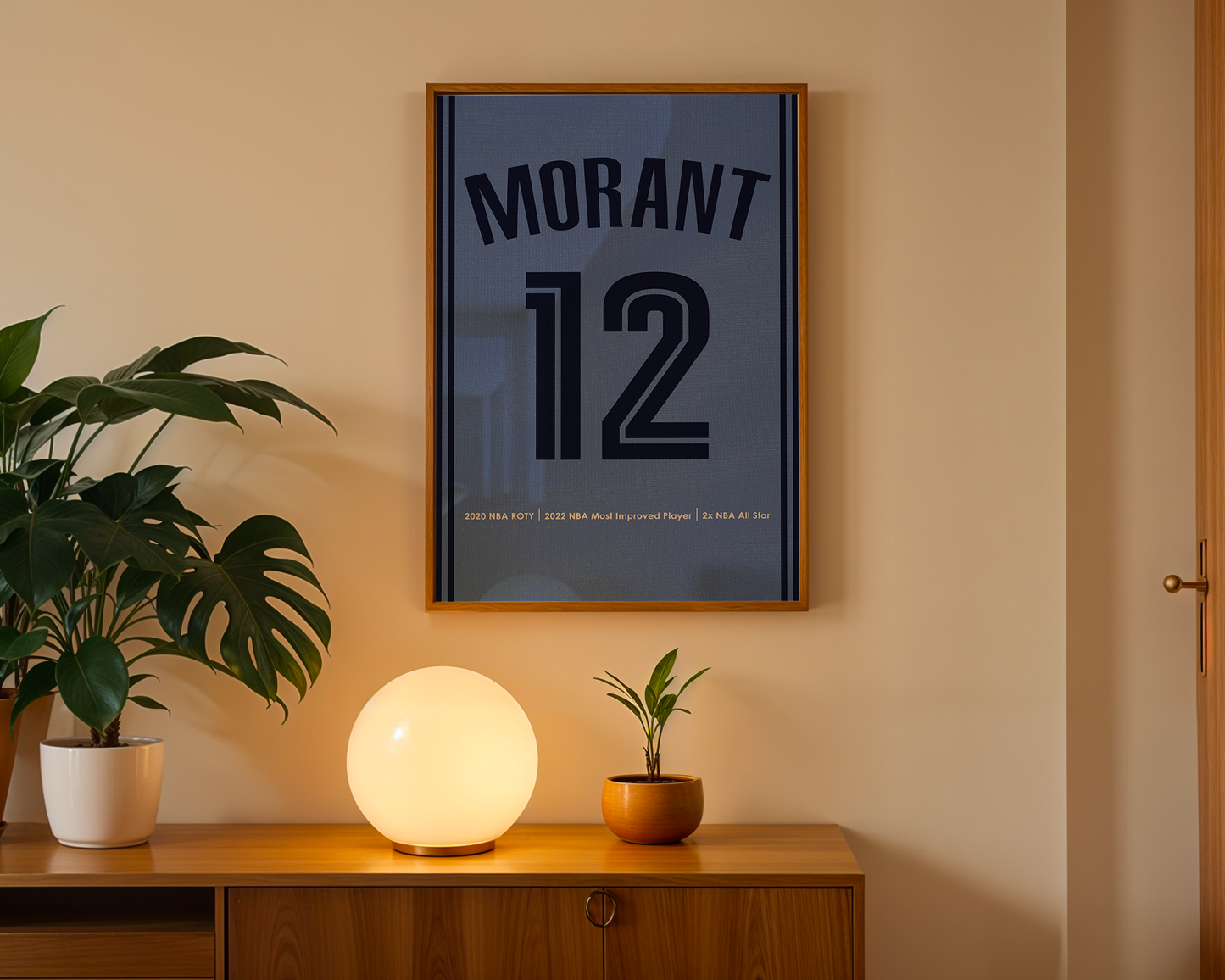 Framed poster with 'Morant 12' on a wall above a wooden cabinet with decorative items.