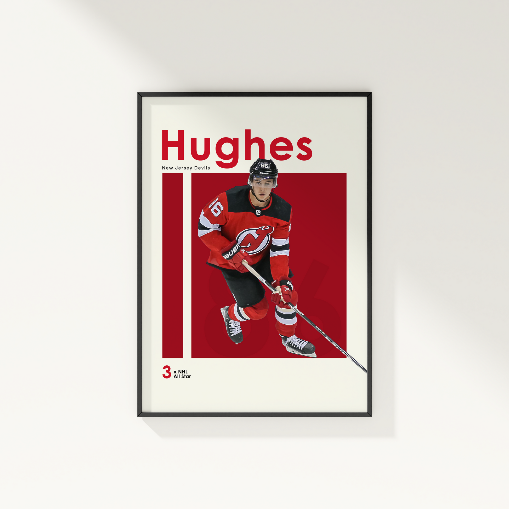 framed poster mockup of hockey player jack hughes hanging on a white wall