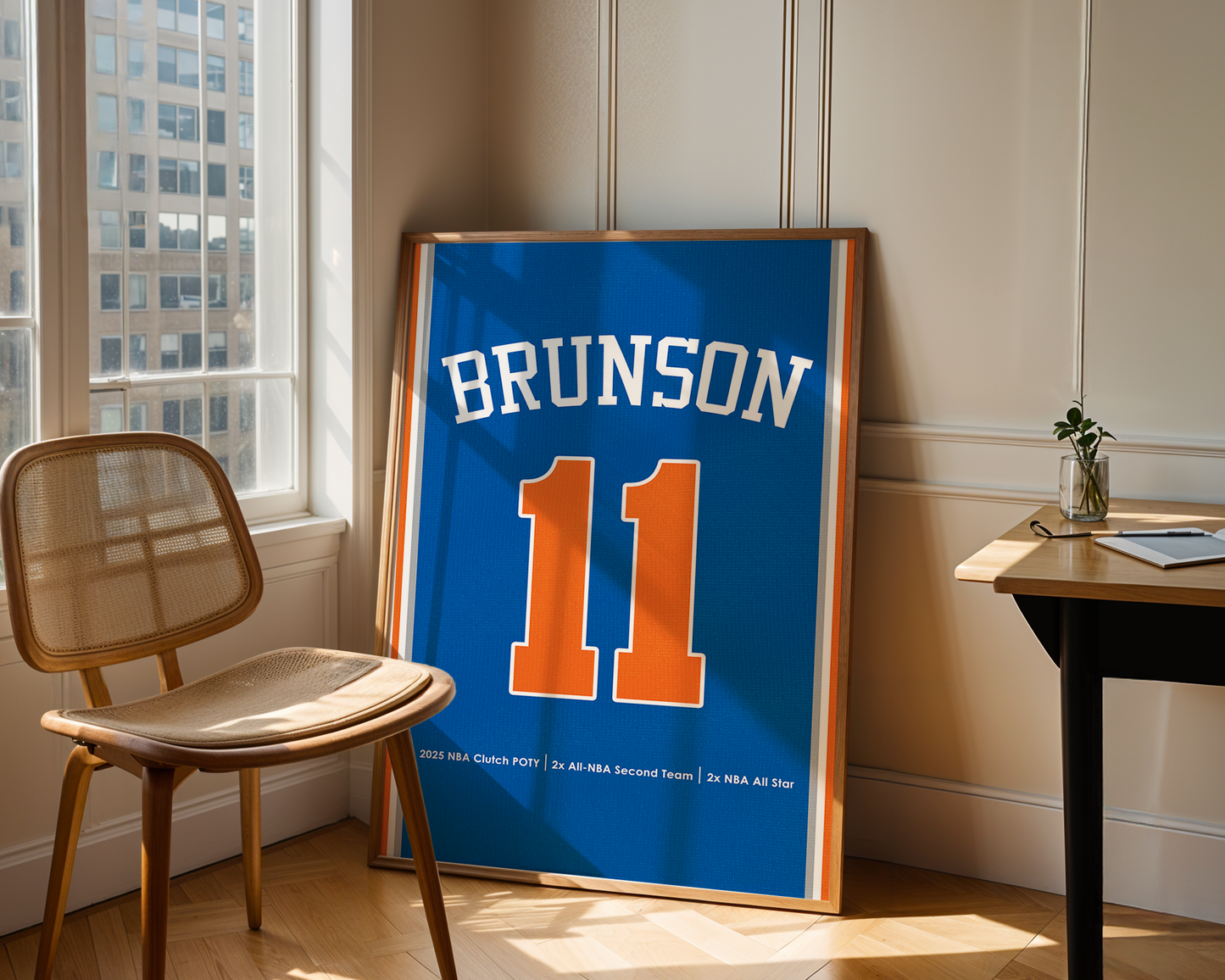 Framed sports jersey with 'Brunson' and number '11' in a room with a window and chair.