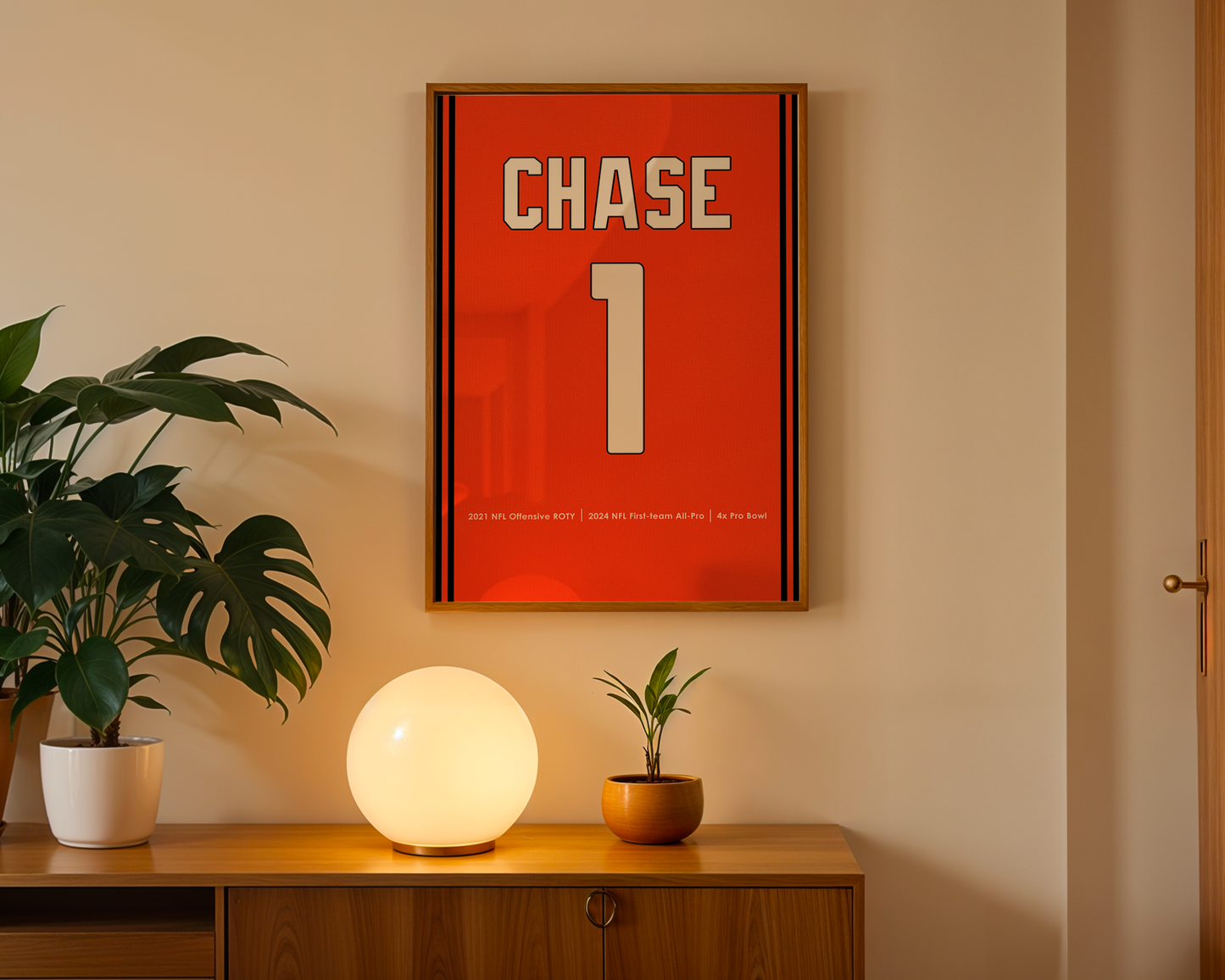 Framed poster with 'CHASE' and number '1' on a wall above a wooden cabinet with decorative items.