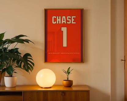 Framed poster with 'CHASE' and number '1' on a wall above a wooden cabinet with decorative items.
