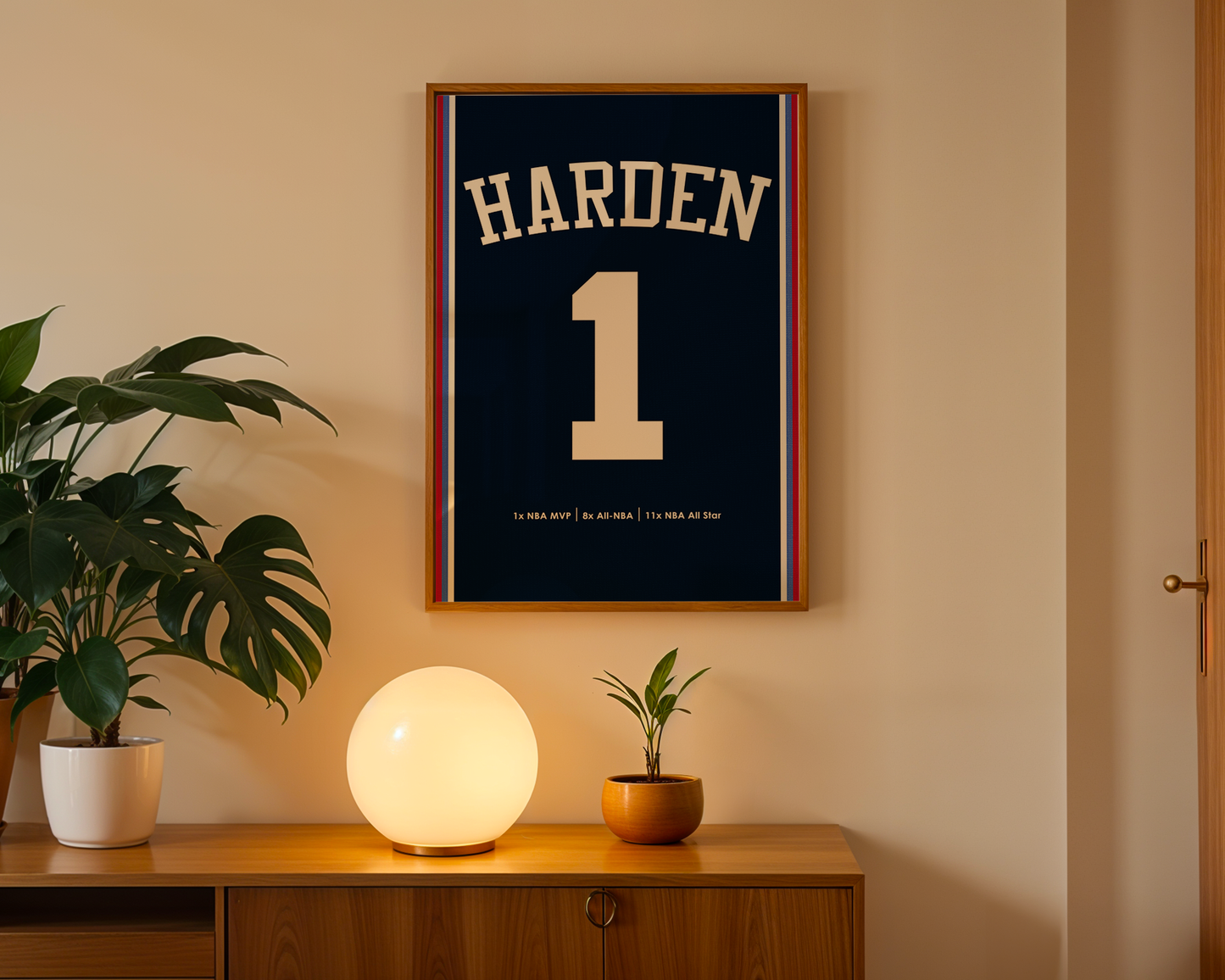Framed sports jersey with 'Harden' and number '1' on a wall above a wooden cabinet with decorative items.