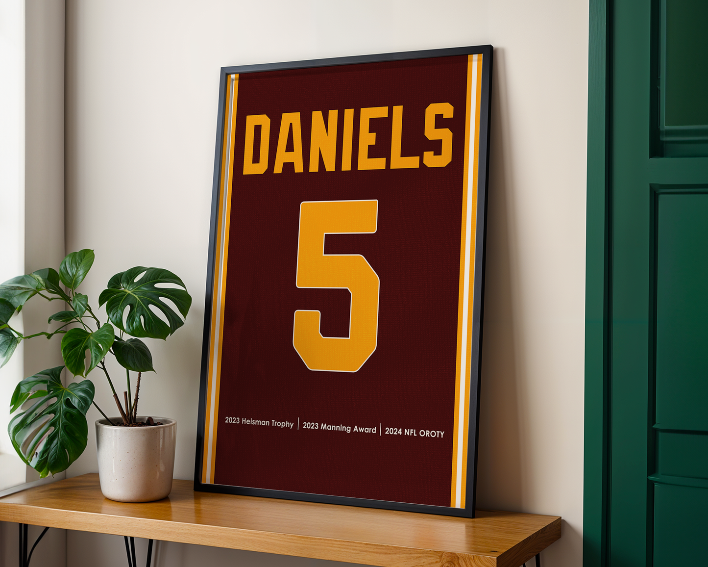 Framed sports jersey with 'Daniels' and number '5' on a wooden shelf.