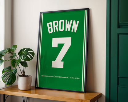 Framed sports jersey with 'Brown' and number '7' on a wooden shelf.