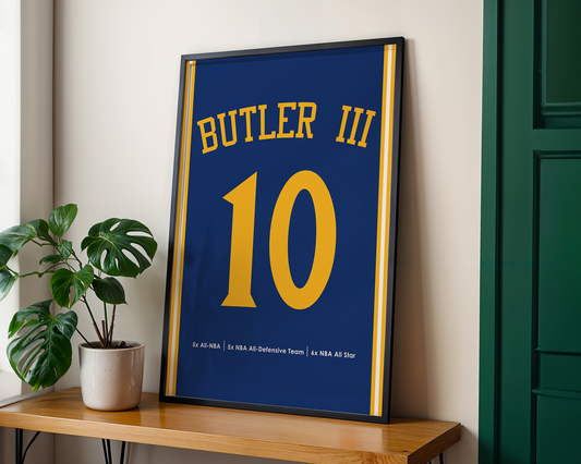 Framed sports jersey with 'Butler III' and number '10' on a wooden shelf.