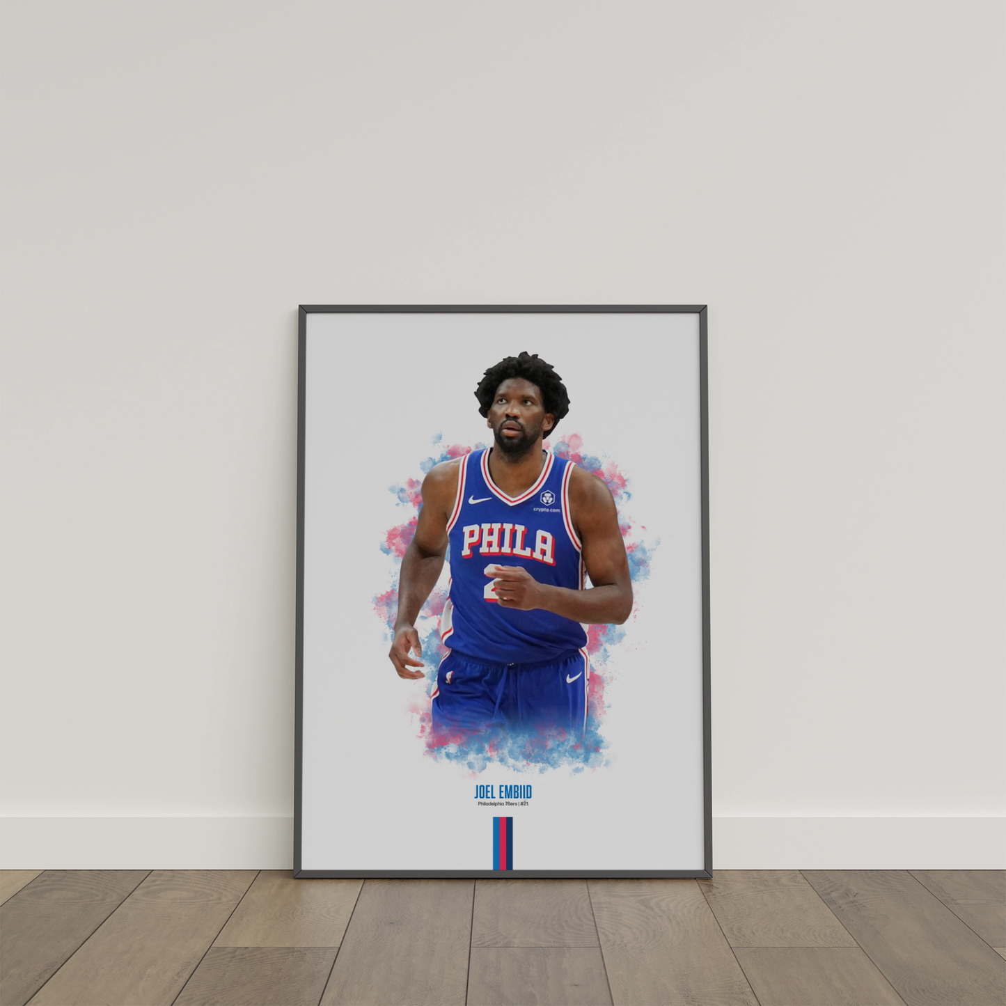 framed poster mockup of basketball player joel embiid leaning on a white wall