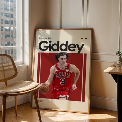 Framed poster of a basketball player in a red jersey with 'Giddey' text, leaning against a wall in a room with a chair and table.