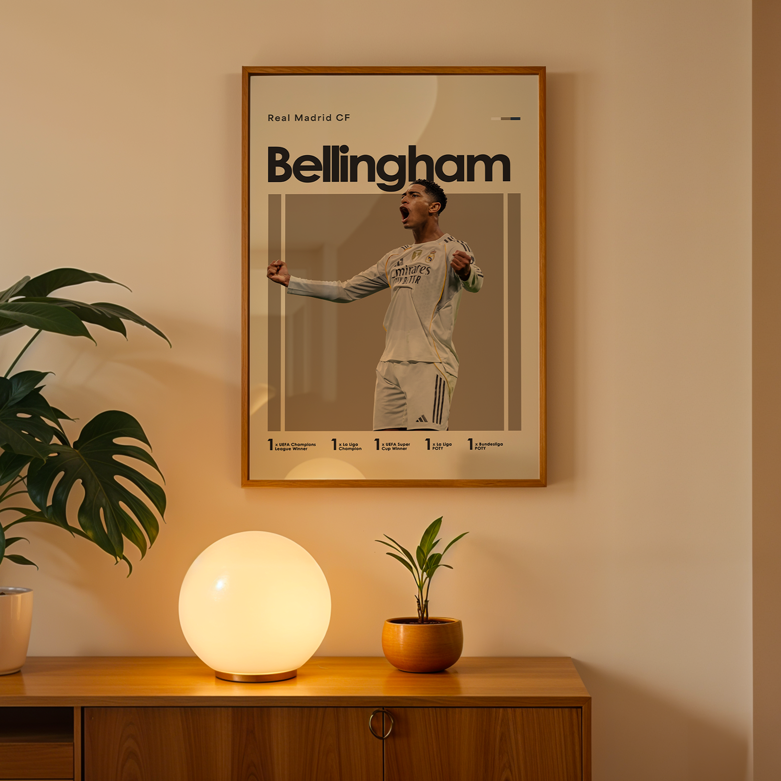 Framed poster of a sports player named Bellingham on a wall above a wooden cabinet with decorative items.