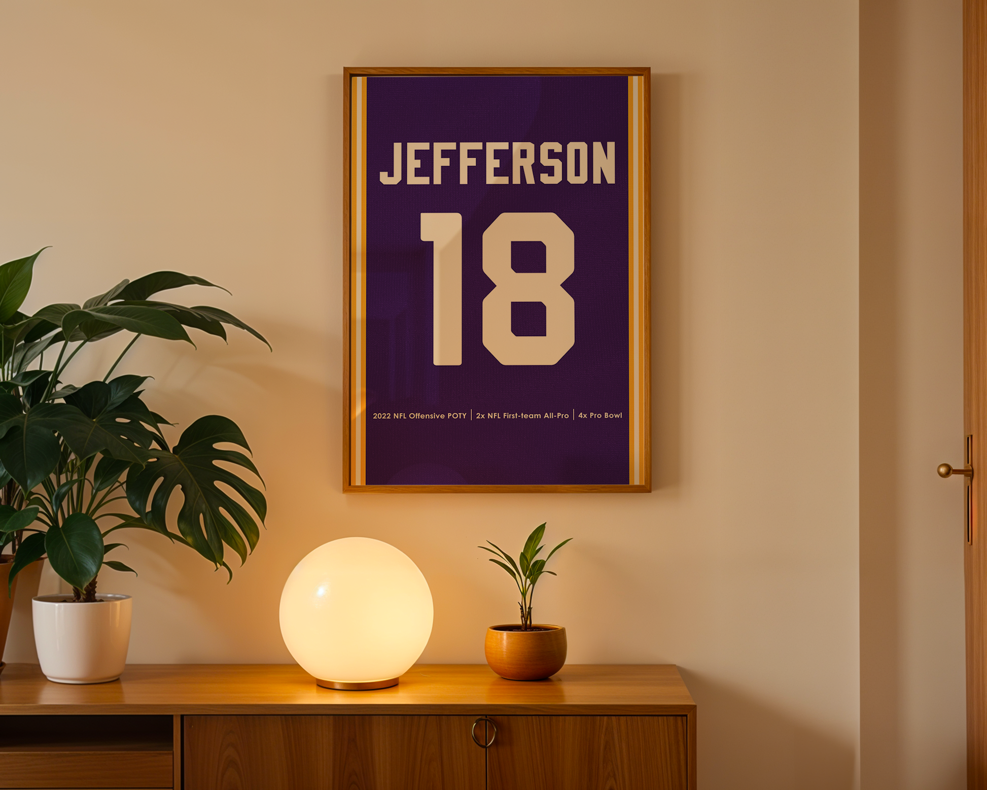 Framed poster with 'JEFFERSON 18' on a wall above a wooden cabinet with decorative items.